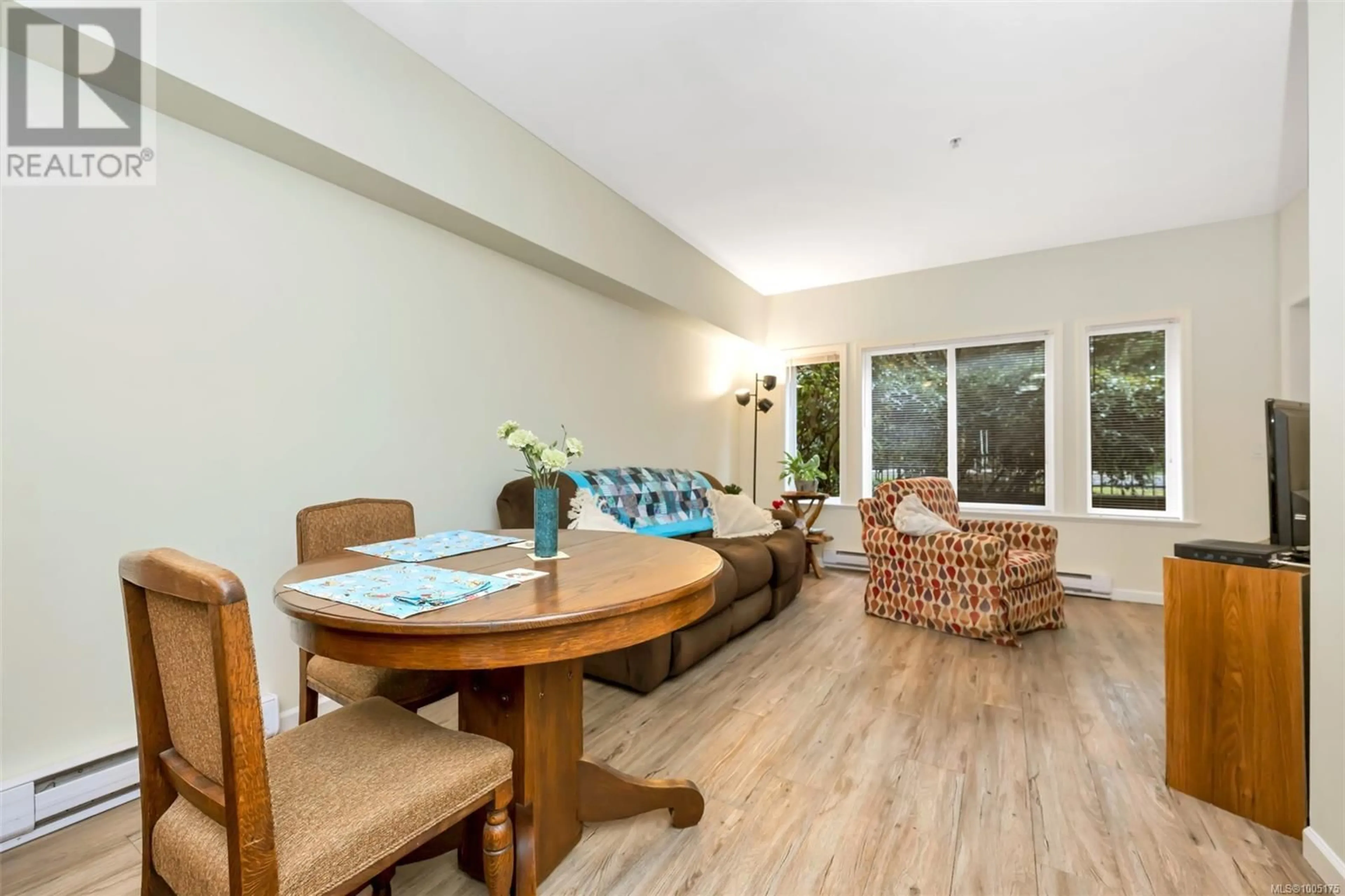 Living room with furniture, wood/laminate floor for 103 - 360 GOLDSTREAM AVENUE, Colwood British Columbia V9B2W3