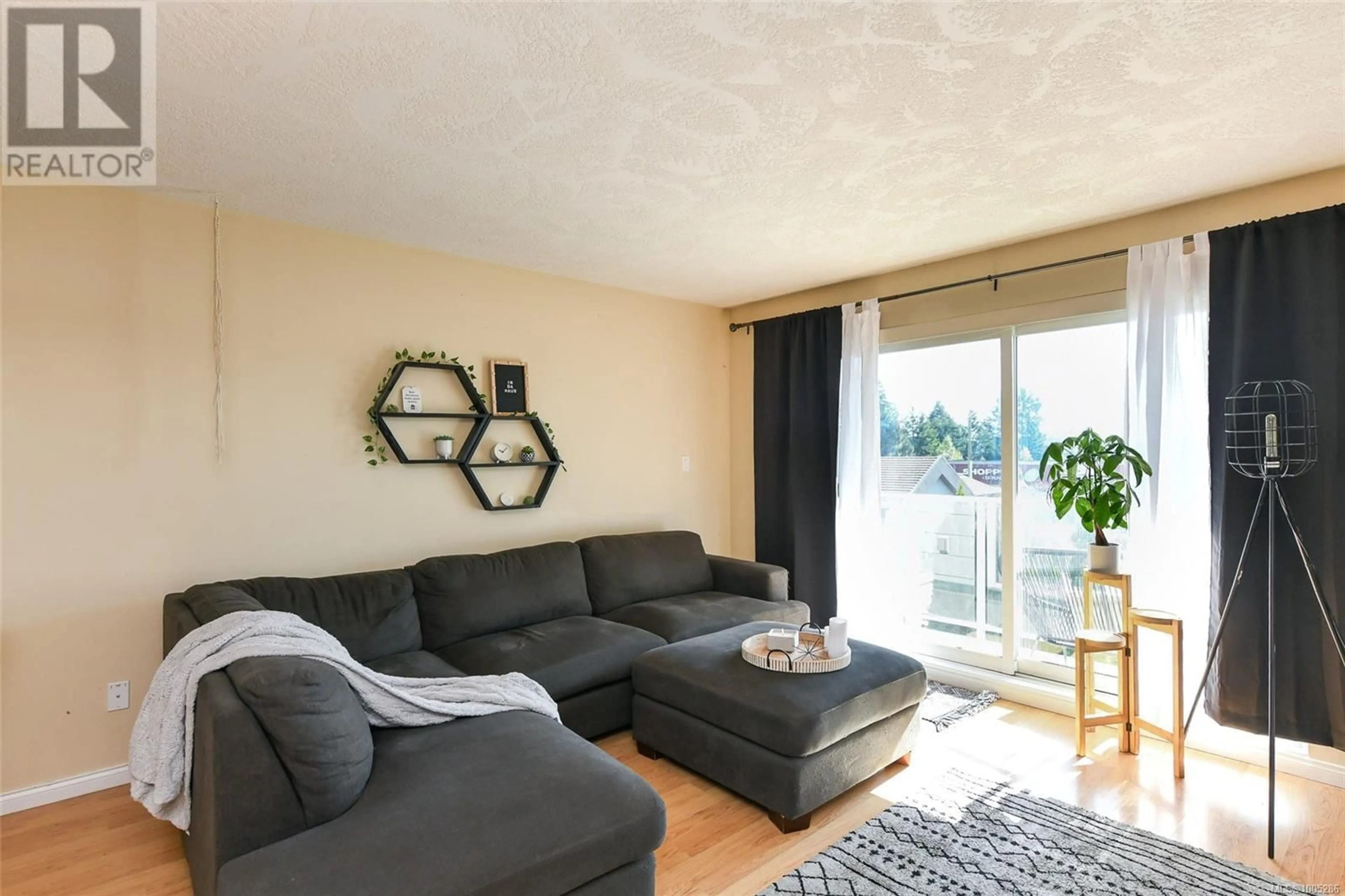 Living room with furniture, wood/laminate floor for 305 - 840 SHAMROCK PLACE, Comox British Columbia V9M4G4