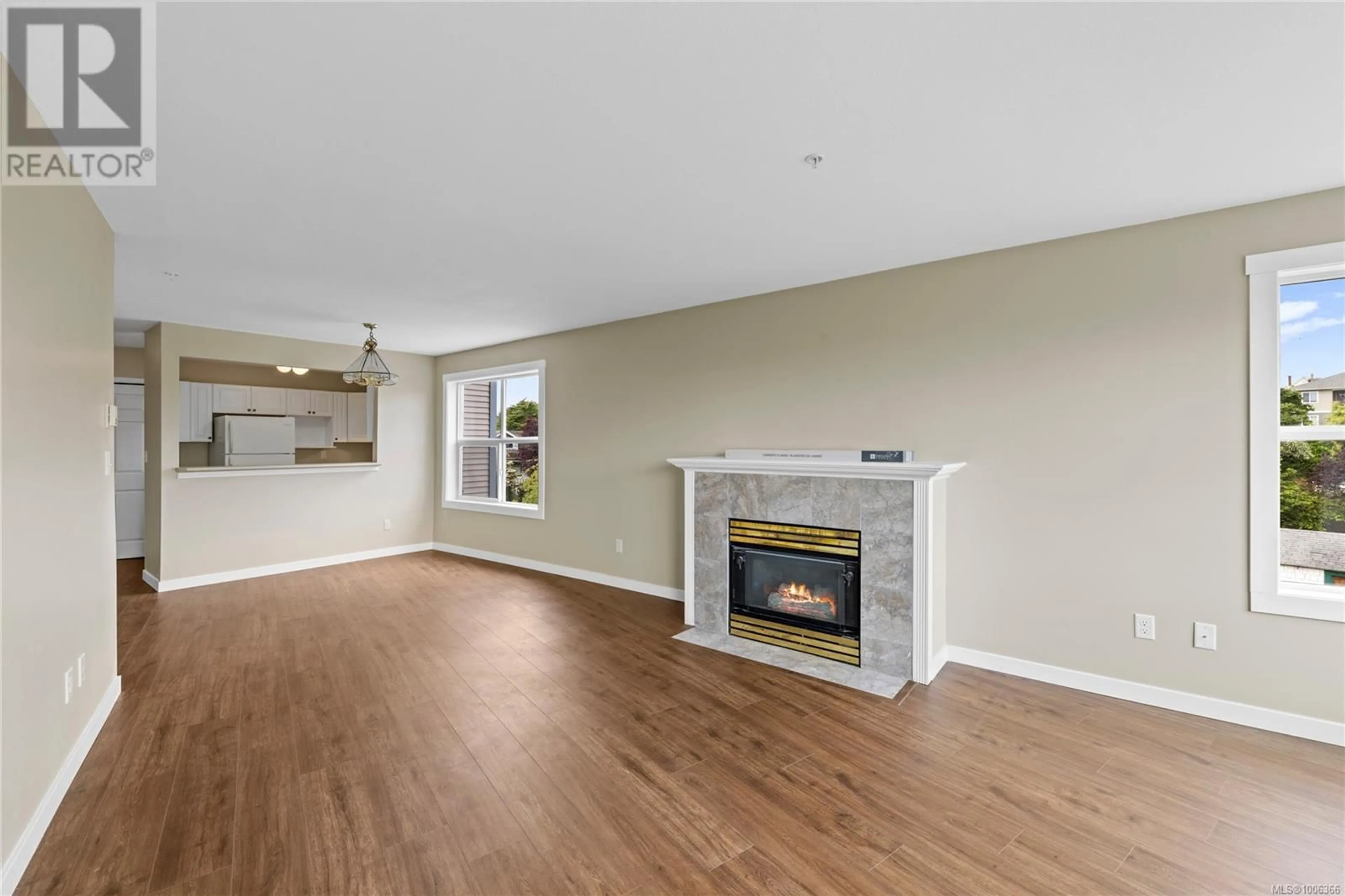 Living room with furniture, wood/laminate floor for 304 - 650 PRIDEAUX STREET, Nanaimo British Columbia V9R2P1