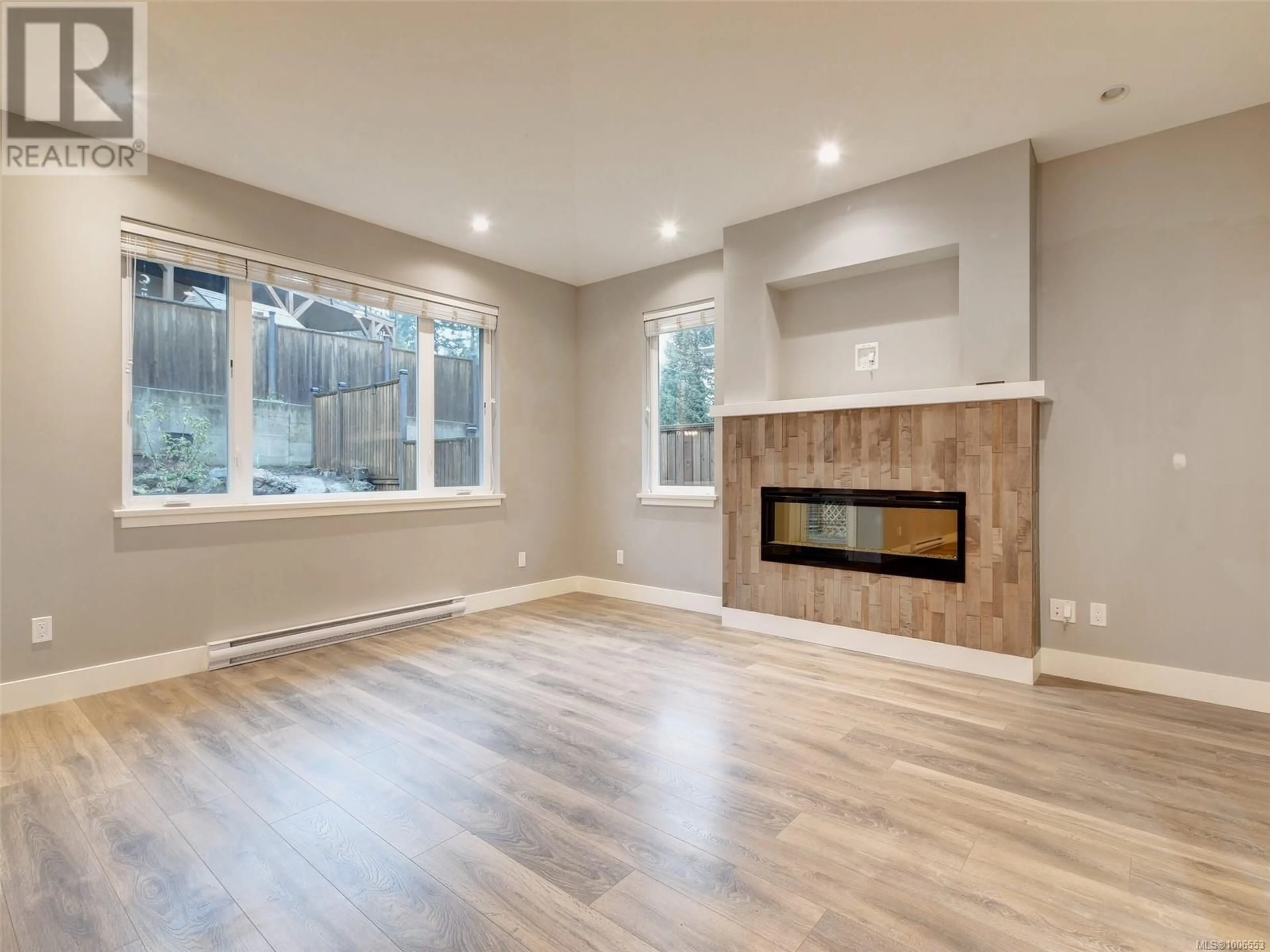 Living room with furniture, wood/laminate floor for 6516 ARRANWOOD DRIVE, Sooke British Columbia V9Z0W3