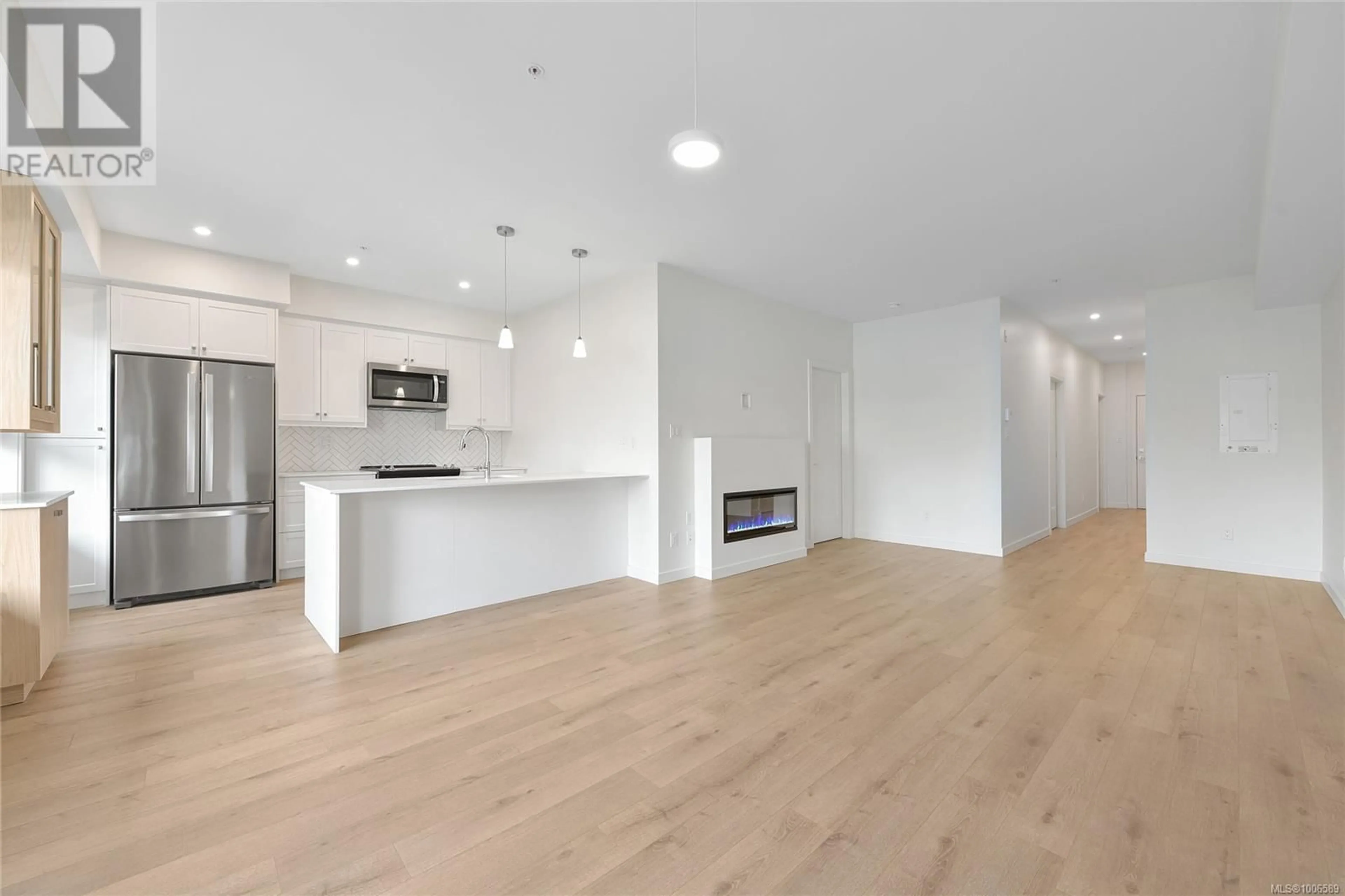 Open concept kitchen, wood/laminate floor for 203 - 9716 THIRD STREET, Sidney British Columbia V8L3A2