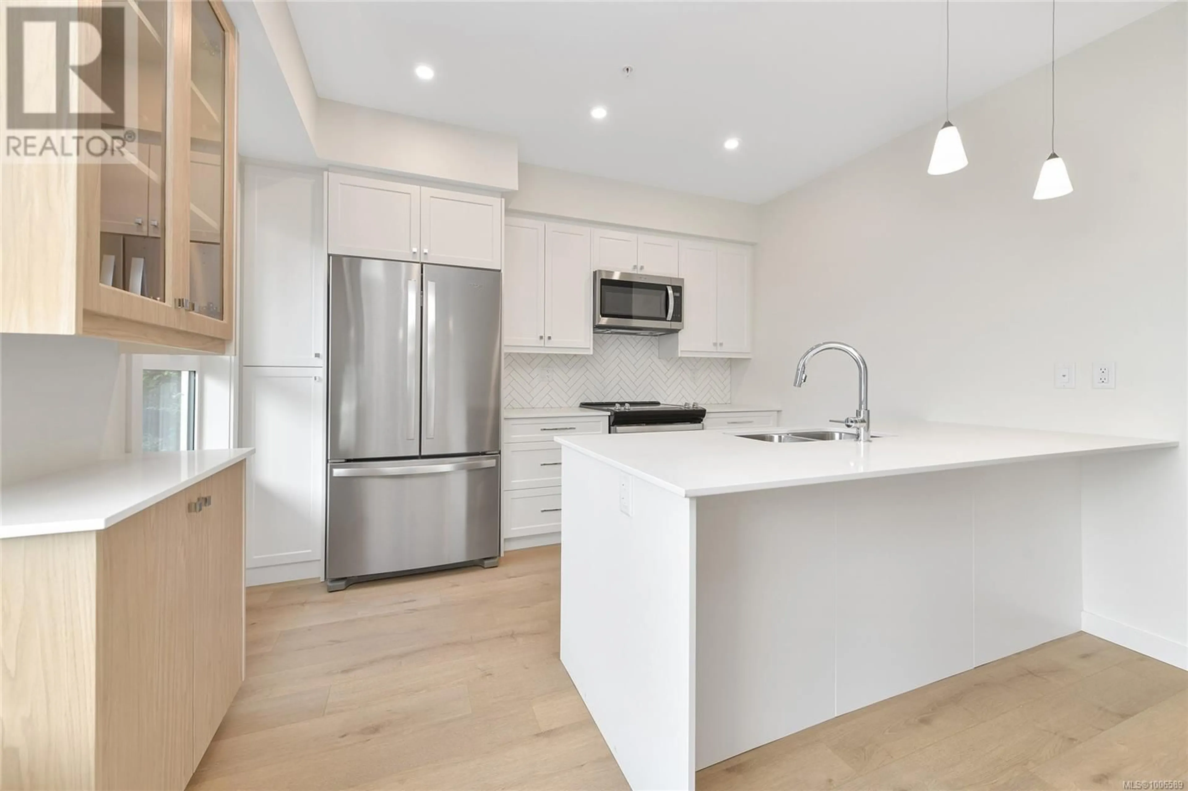 Open concept kitchen, wood/laminate floor for 203 - 9716 THIRD STREET, Sidney British Columbia V8L3A2