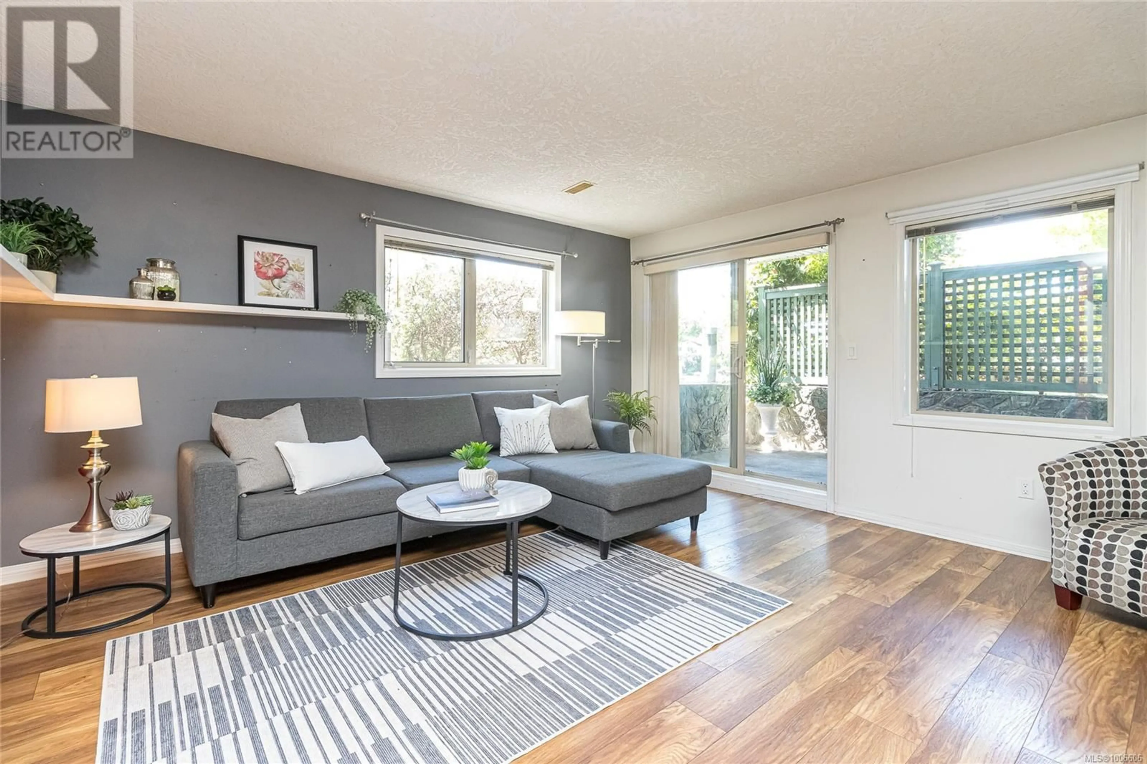 Living room with furniture, wood/laminate floor for 104 - 3157 TILLICUM ROAD, Saanich British Columbia V9A2B4