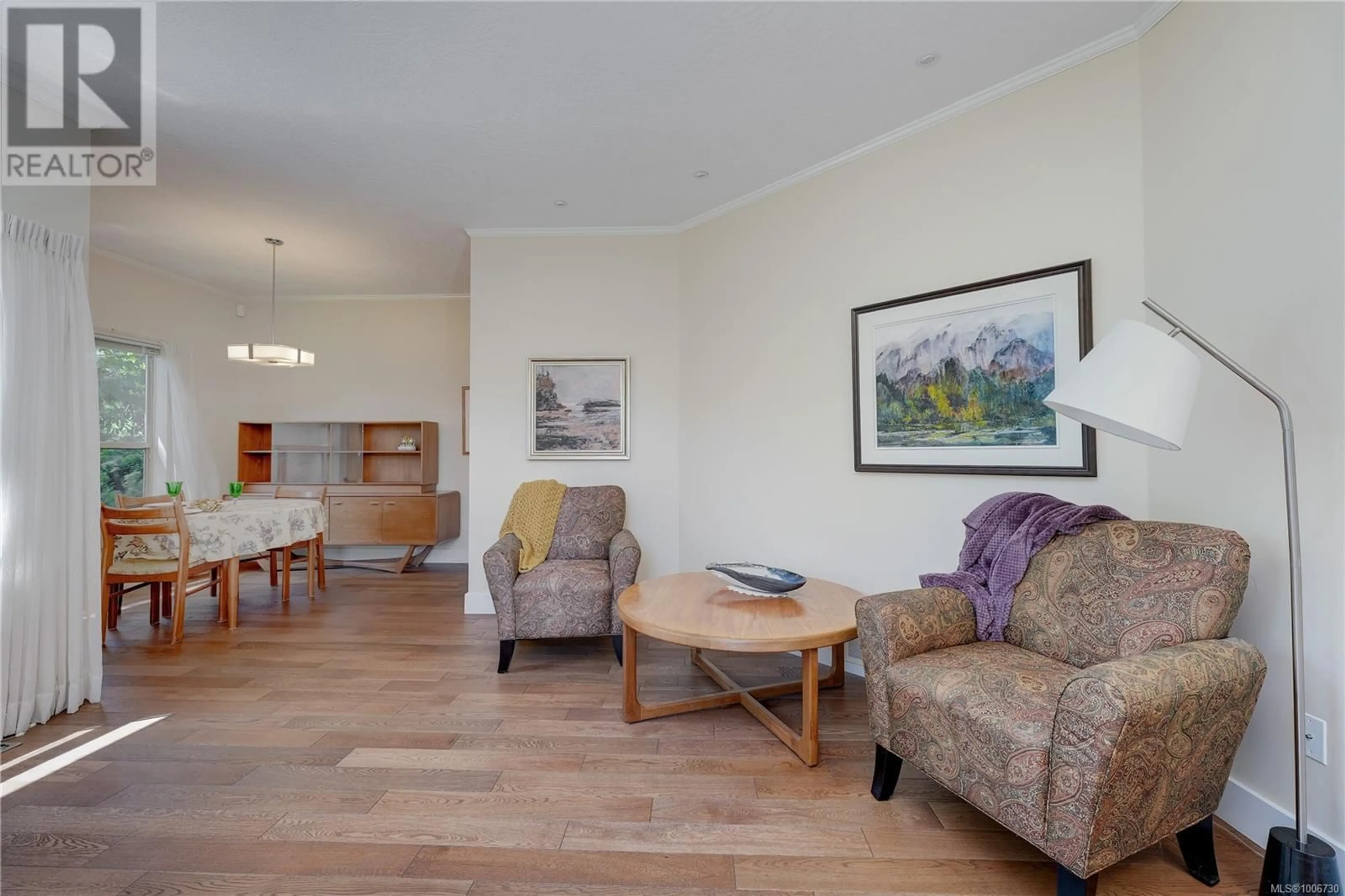 Living room with furniture, wood/laminate floor for 703 - 4515 PIPELINE ROAD, Saanich British Columbia V8Z5M3