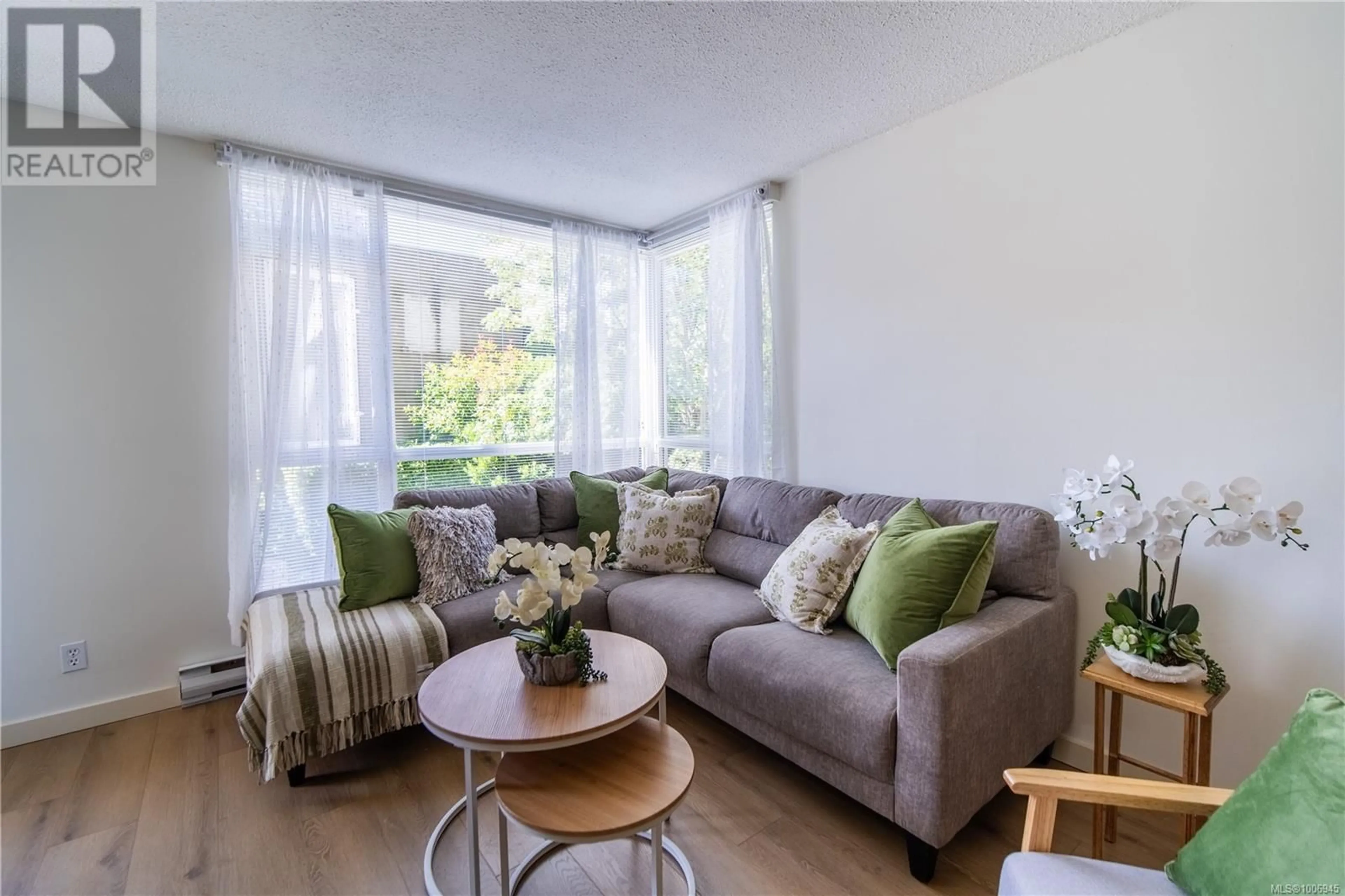 Living room with furniture, wood/laminate floor for 210 - 835 VIEW STREET, Victoria British Columbia V8W3W8
