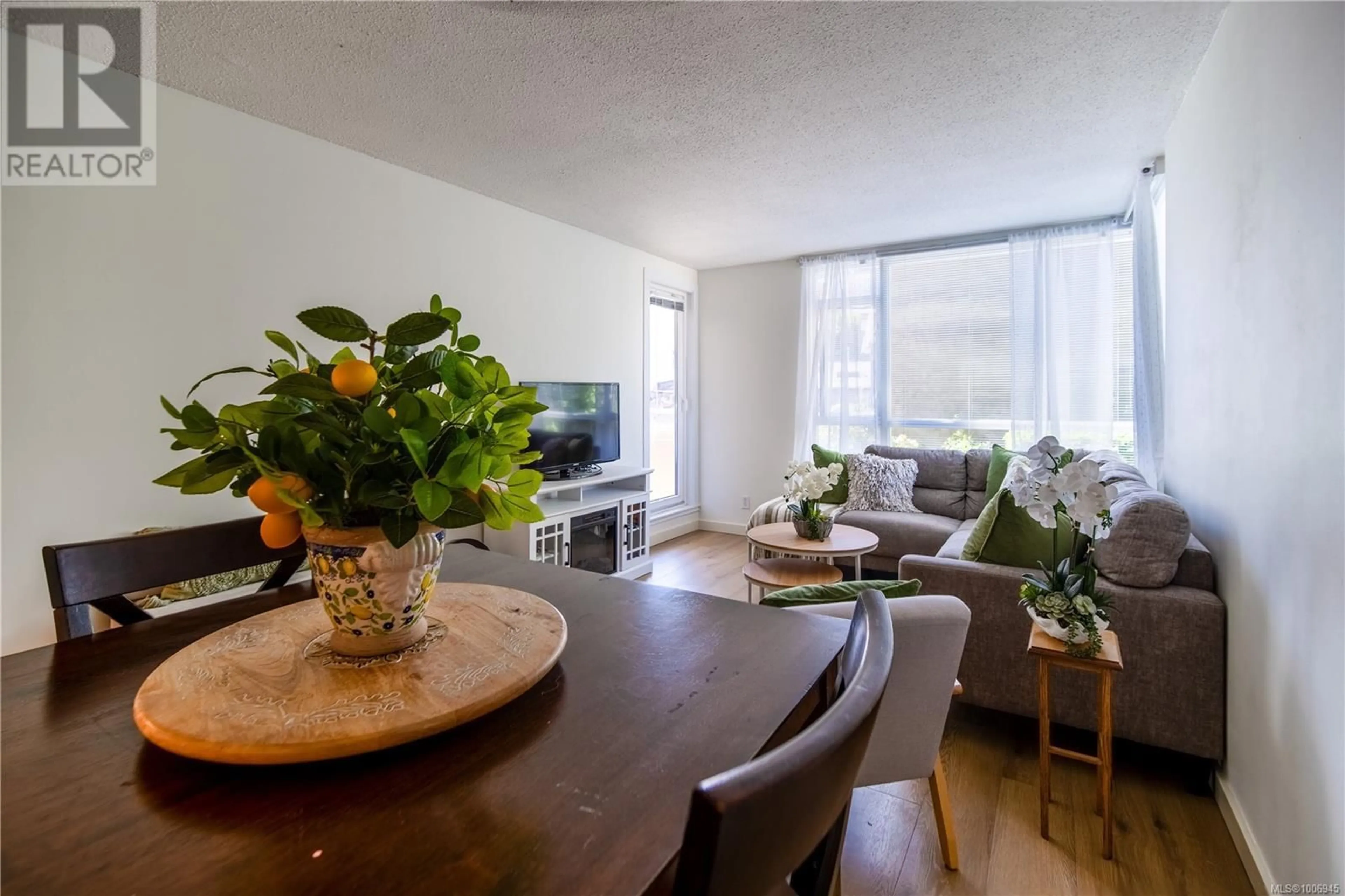 Living room with furniture, wood/laminate floor for 210 - 835 VIEW STREET, Victoria British Columbia V8W3W8