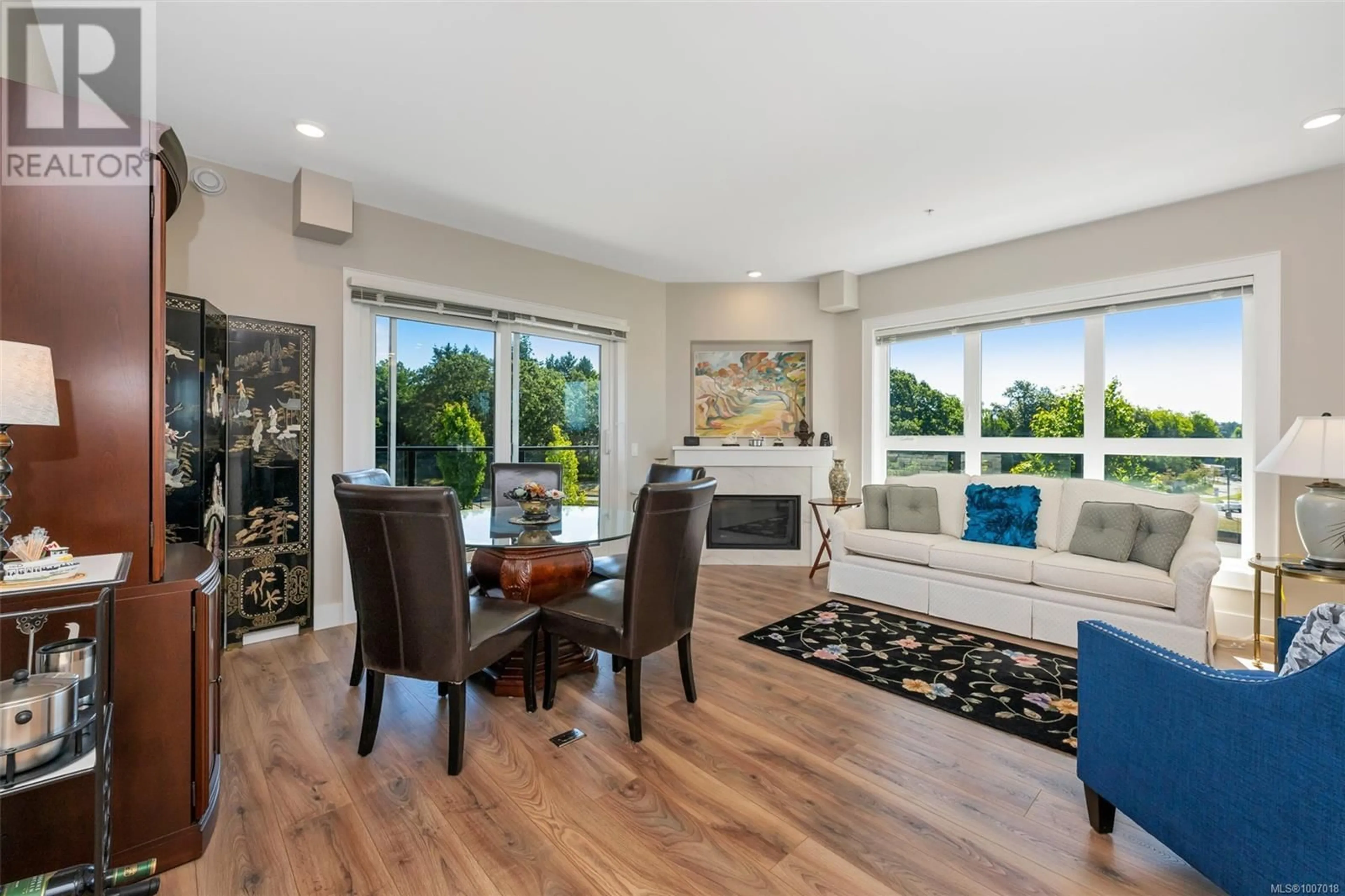 Living room with furniture, wood/laminate floor for 302 - 747 TRAVINO LANE, Saanich British Columbia V8Z0E4