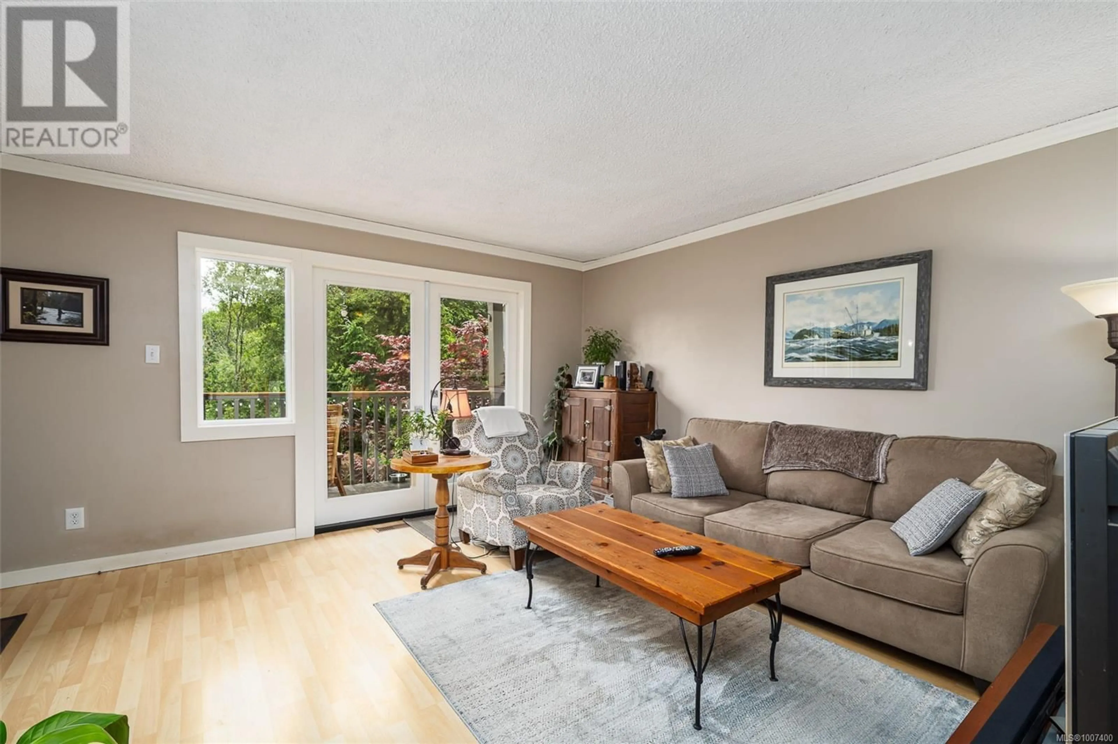Living room with furniture, wood/laminate floor for 561 MACMILLAN DRIVE, Sayward British Columbia V0P1R0