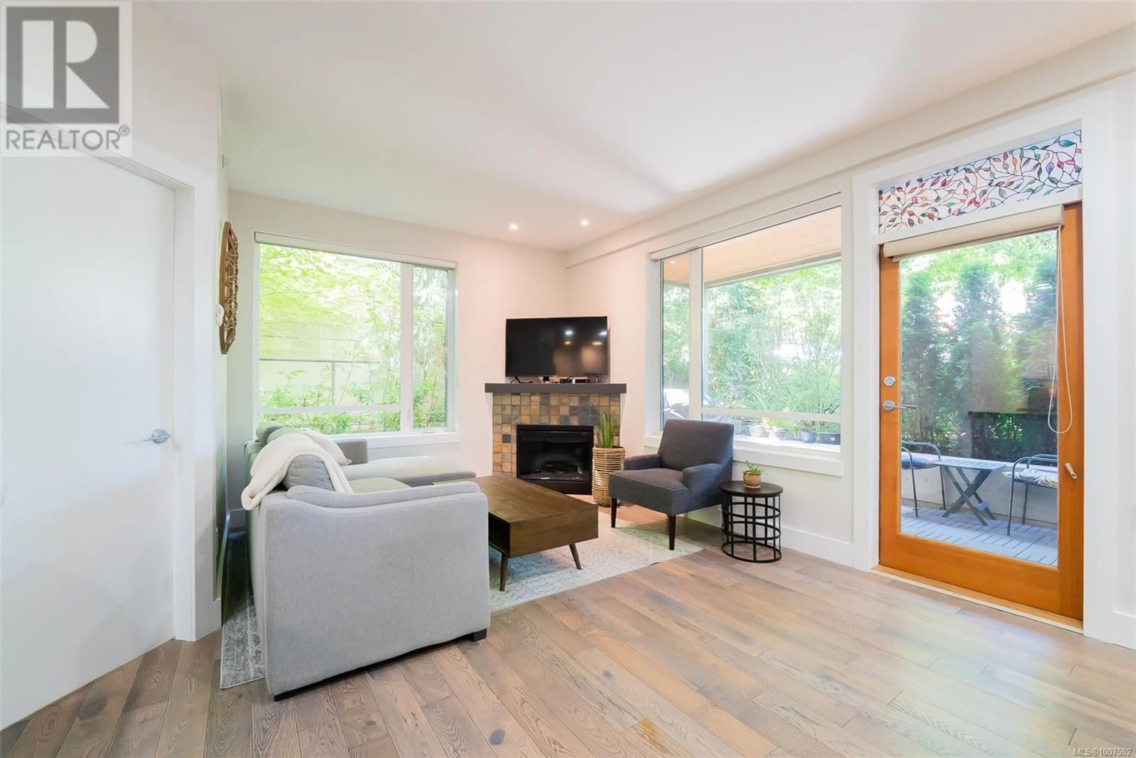 Living room with furniture, wood/laminate floor for 106 - 580 STEWART AVENUE, Nanaimo British Columbia V9S0A1
