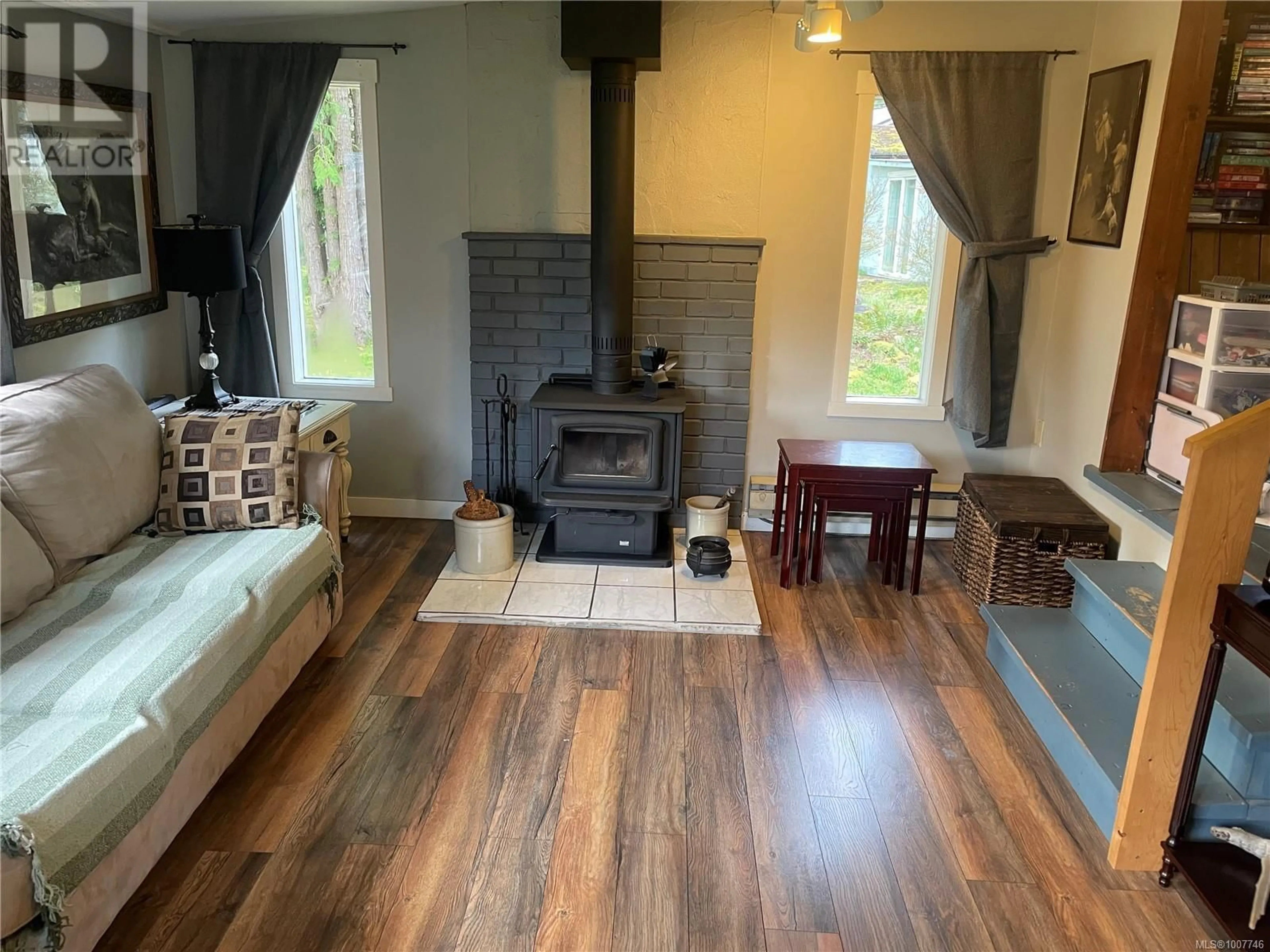 Living room with furniture, wood/laminate floor for 247 HUSON ROAD, Qualicum Beach British Columbia V9K2A2