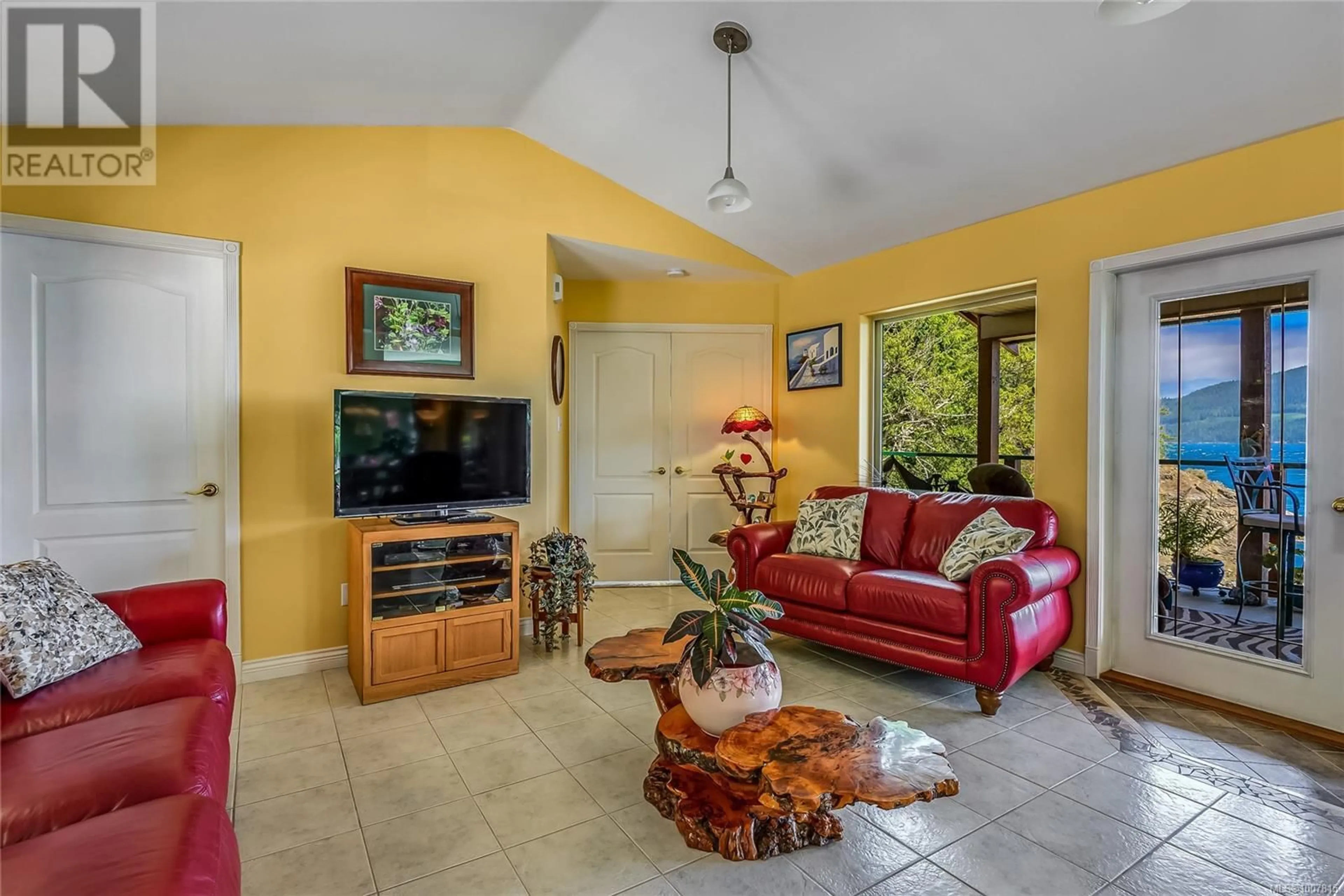 Living room with furniture, ceramic/tile floor for 23 SAYWARD ROAD, Sayward British Columbia V0P1R0