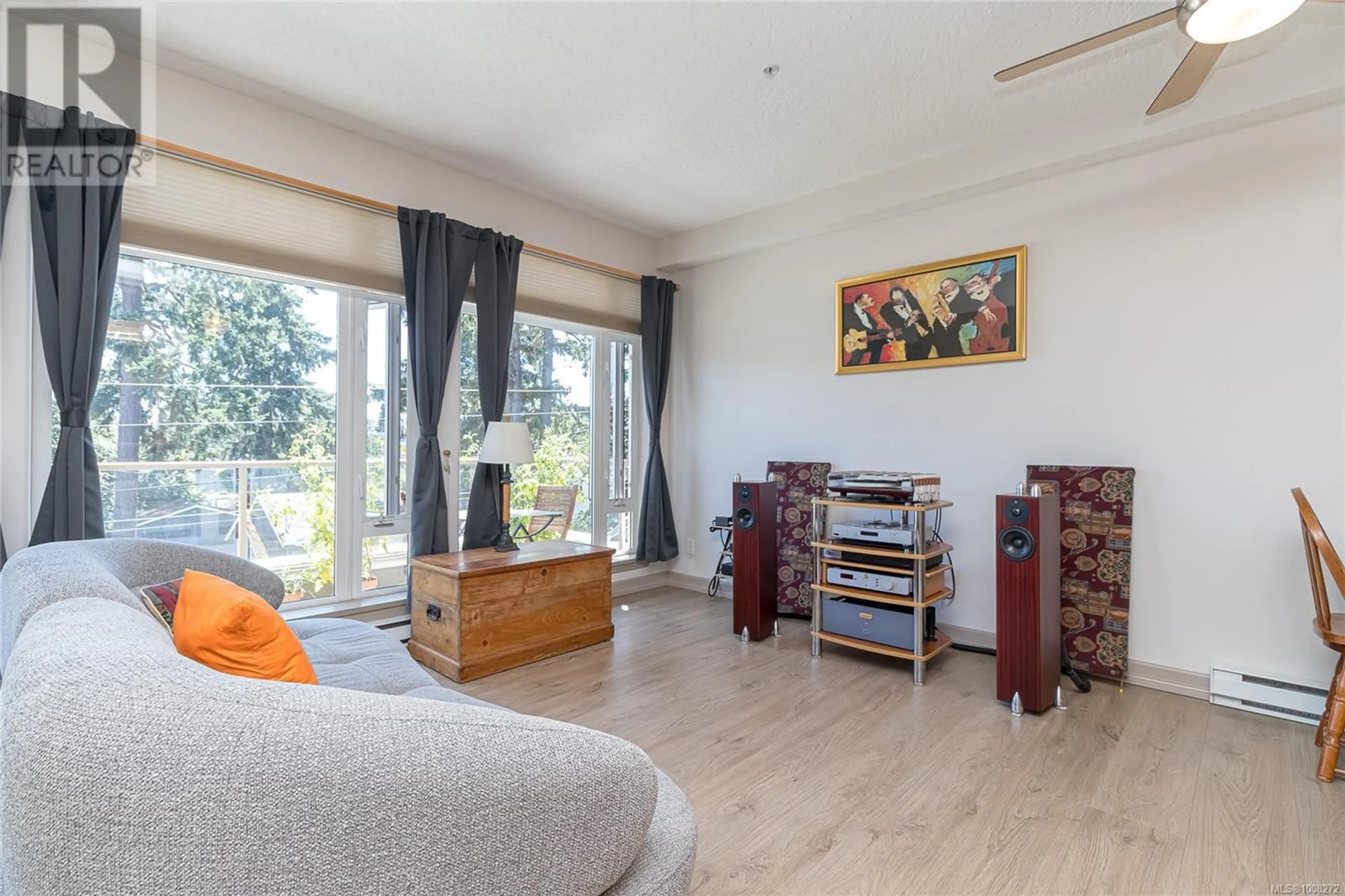 Living room with furniture, wood/laminate floor for 301 - 2706 PEATT ROAD, Langford British Columbia V9B3V3