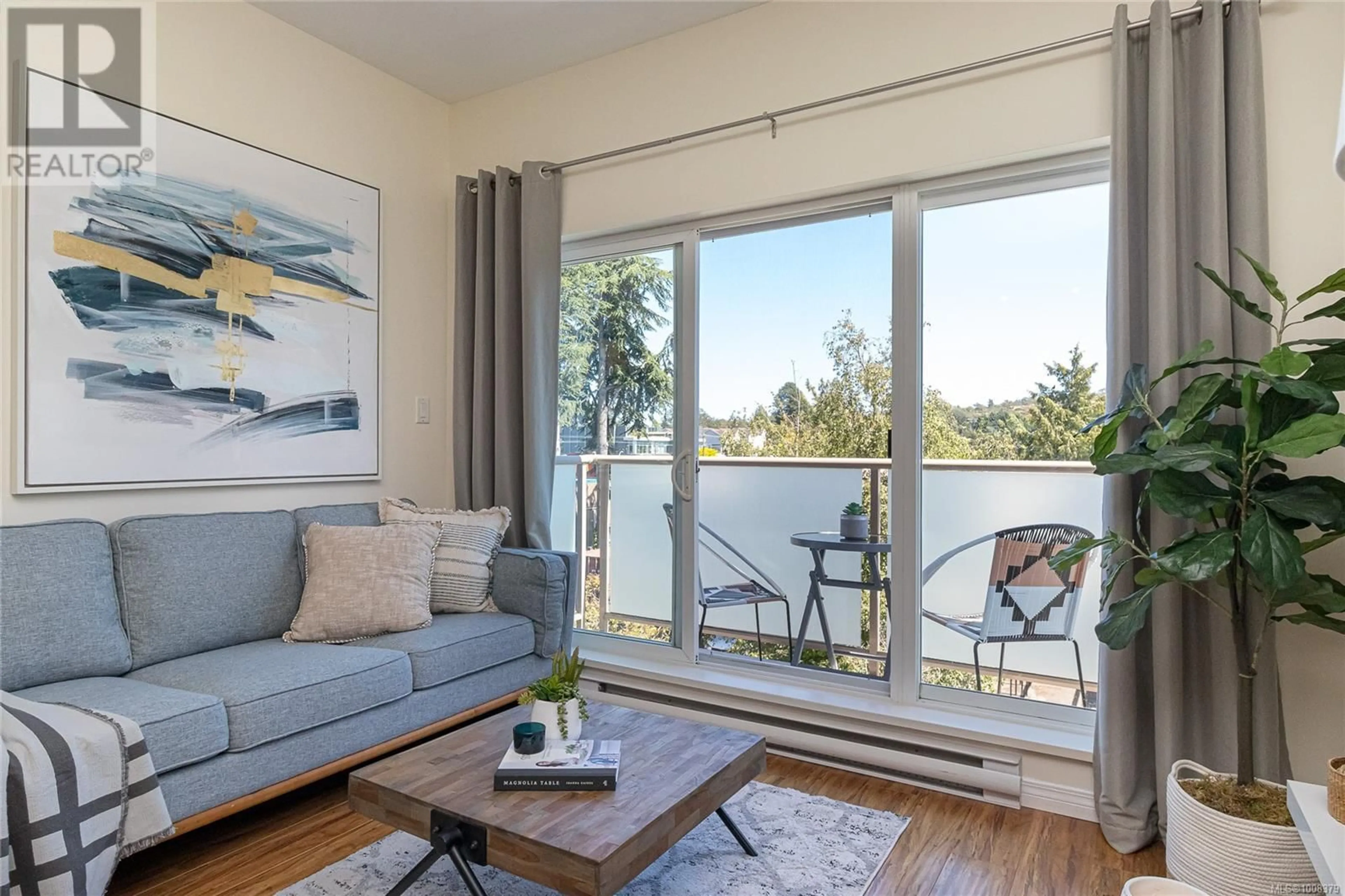 Living room with furniture, wood/laminate floor for 315 - 1550 CHURCH AVENUE, Saanich British Columbia V8P2H1