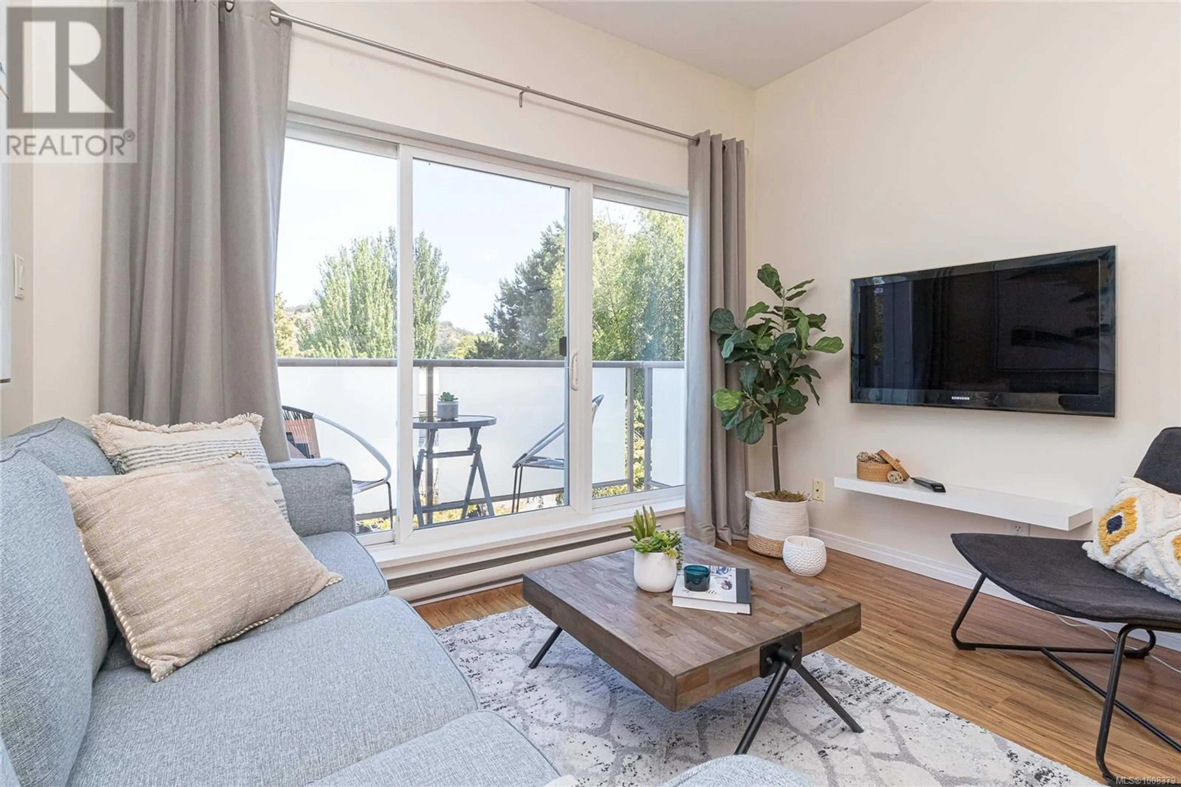 Living room with furniture, wood/laminate floor for 315 - 1550 CHURCH AVENUE, Saanich British Columbia V8P2H1
