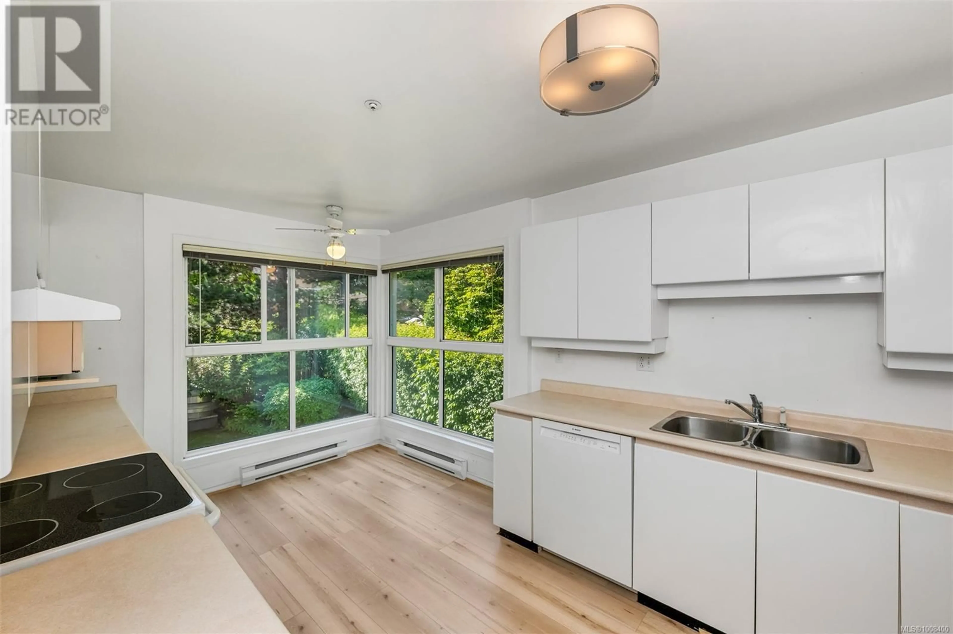 Open concept kitchen, wood/laminate floor for 203 - 525 RITHET STREET, Victoria British Columbia V8V1E4