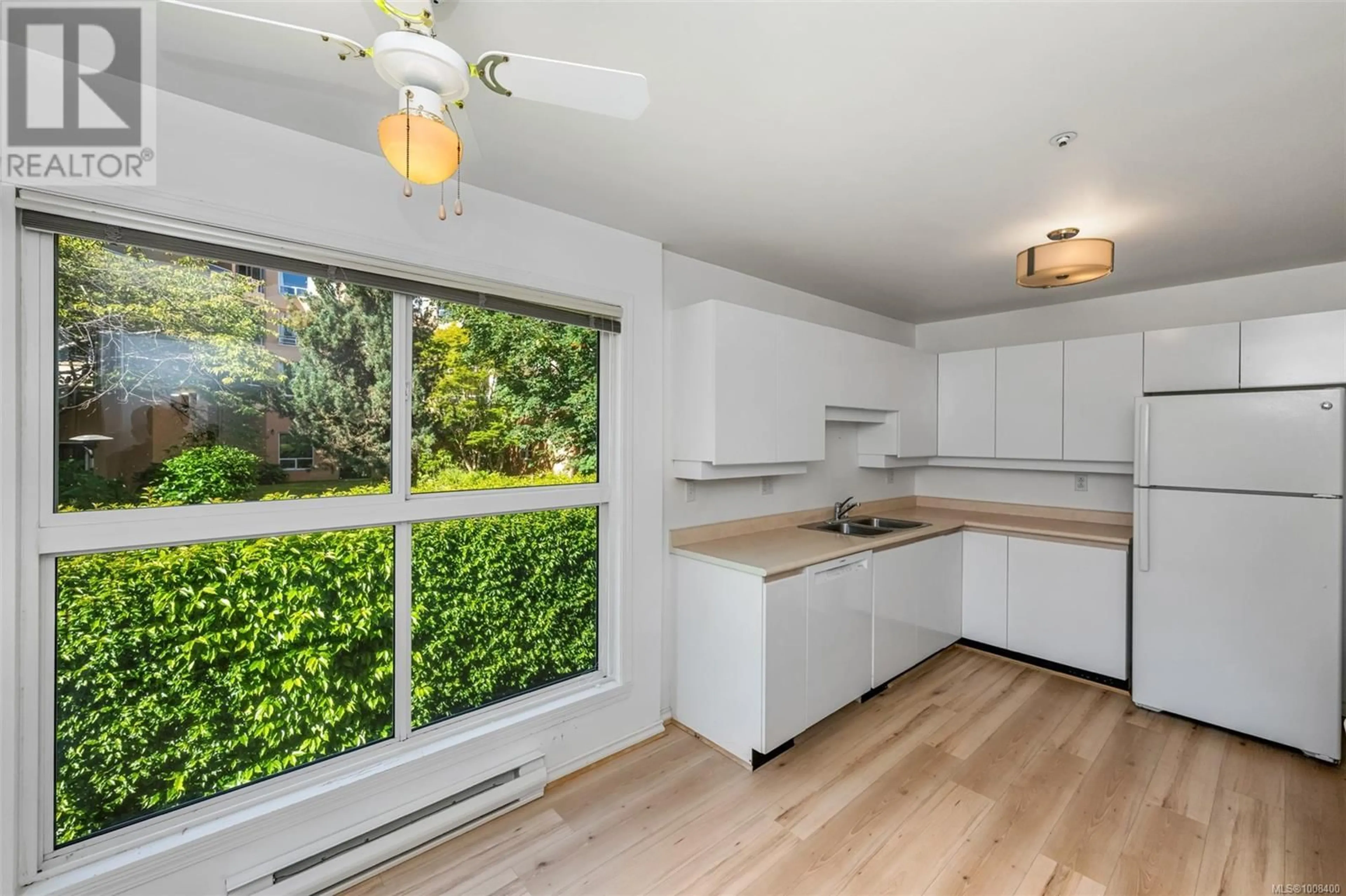 Open concept kitchen, wood/laminate floor for 203 - 525 RITHET STREET, Victoria British Columbia V8V1E4