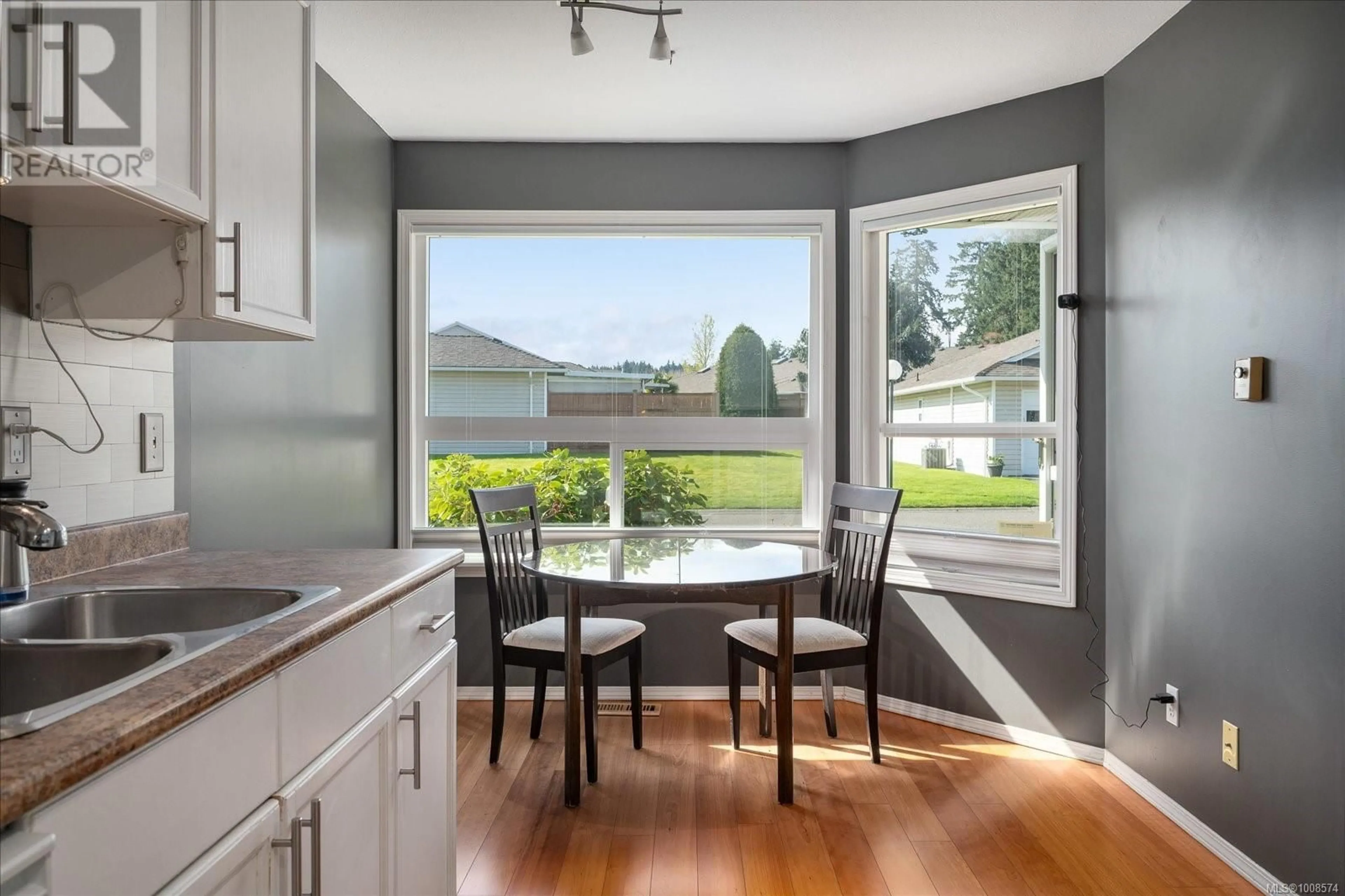 Open concept kitchen, wood/laminate floor for 102 - 240 STANFORD AVENUE EAST, Parksville British Columbia V9P2K8