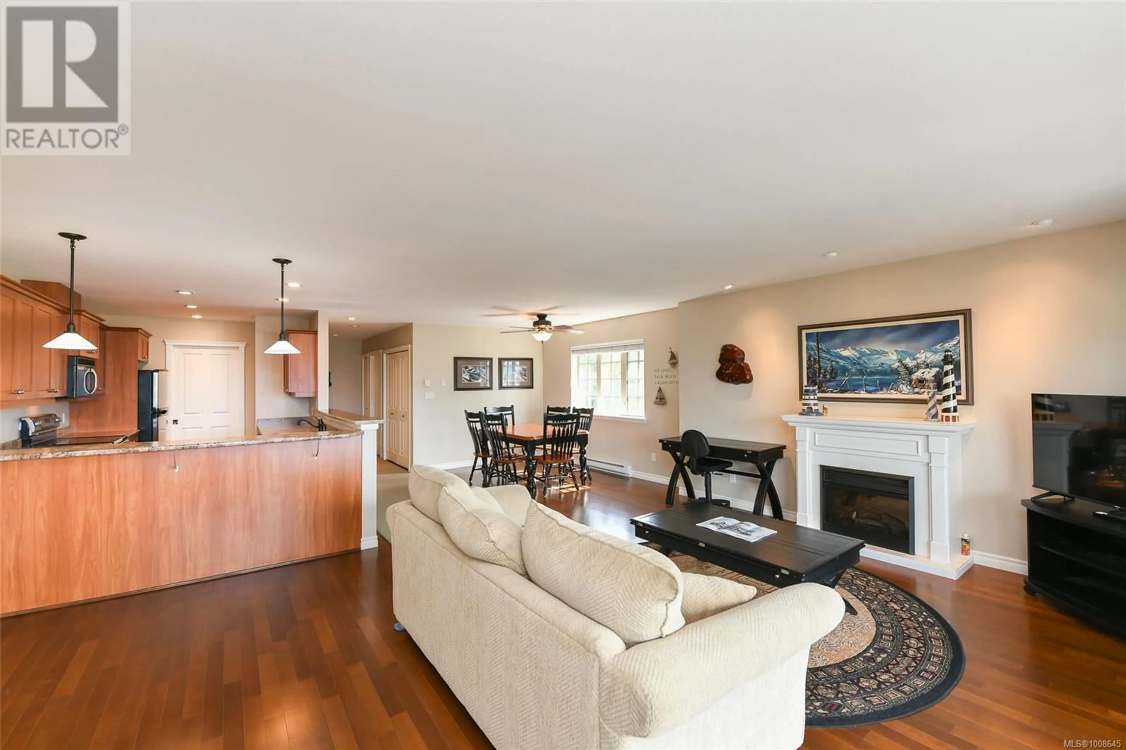 Living room with furniture, wood/laminate floor for 301 - 1705 COMOX AVENUE, Comox British Columbia V9M3M1