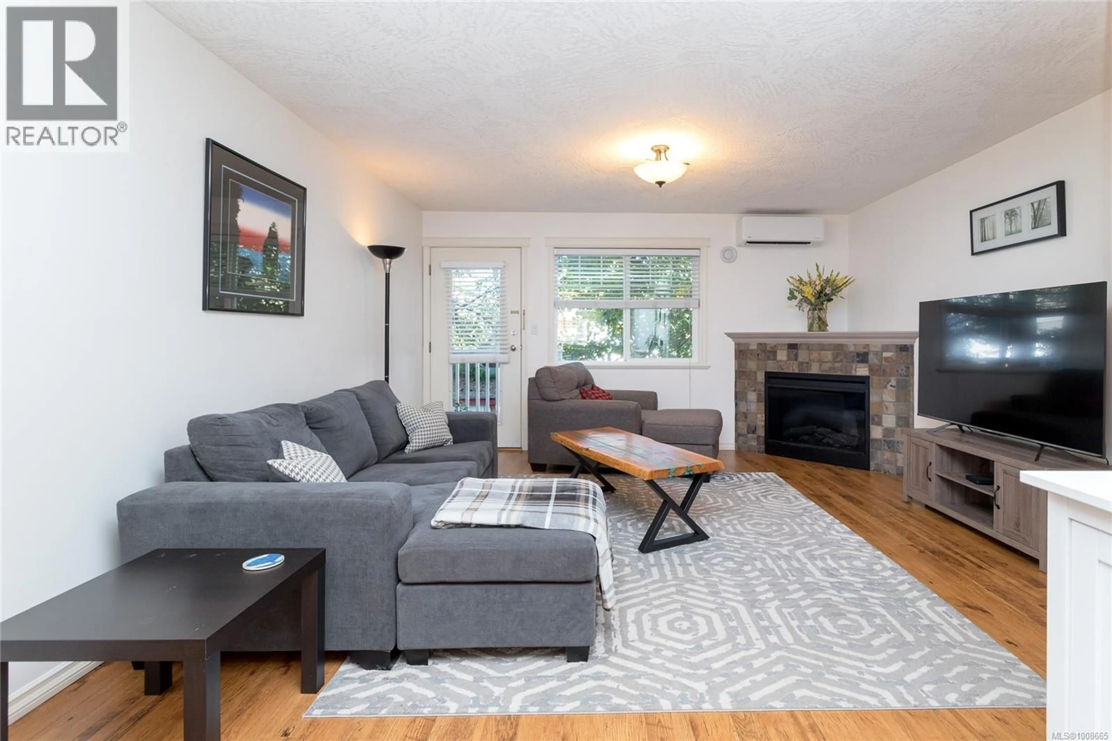 Living room with furniture, wood/laminate floor for 108 - 2766 PEATT ROAD, Langford British Columbia V9B3V3
