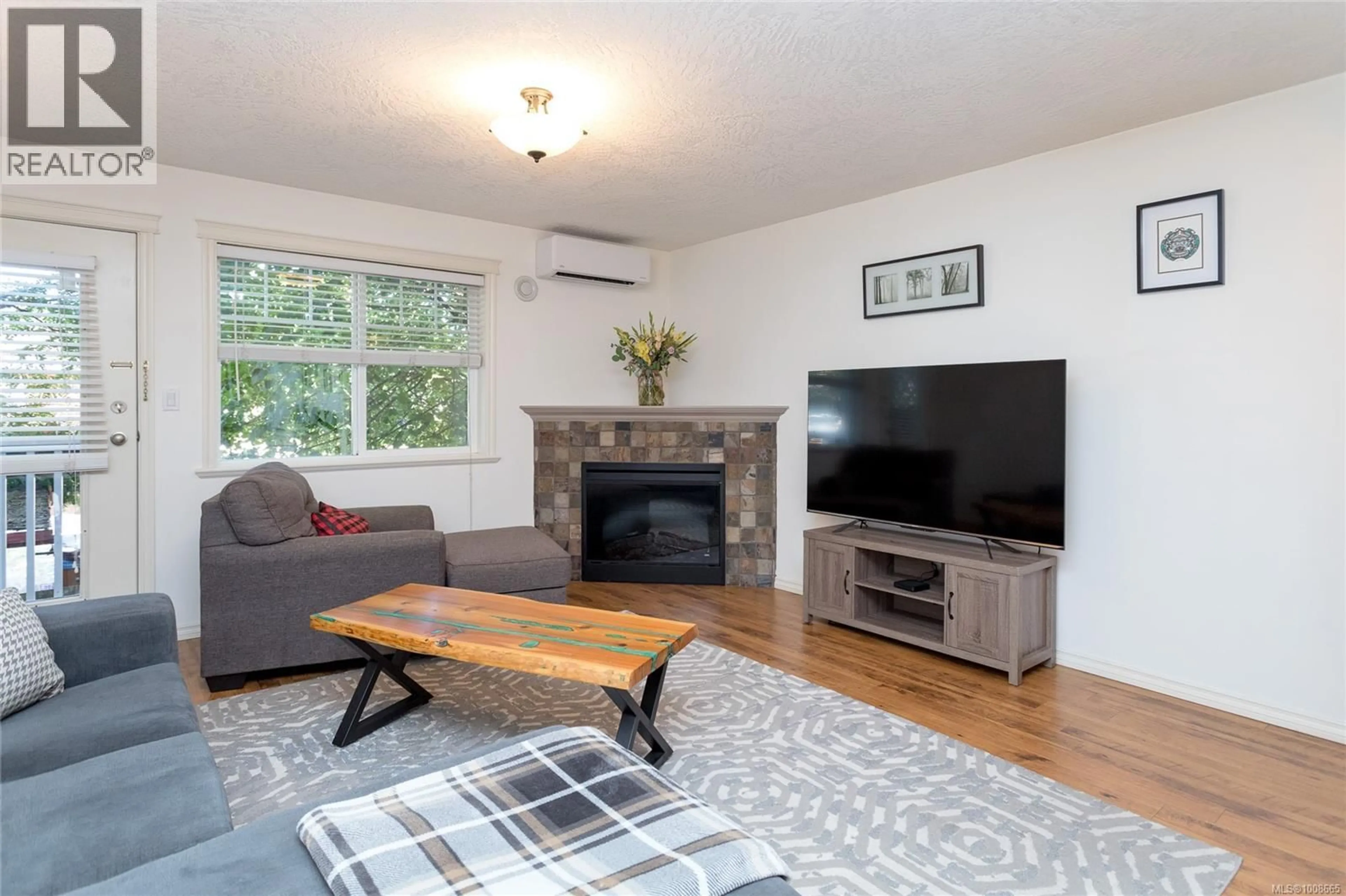 Living room with furniture, wood/laminate floor for 108 - 2766 PEATT ROAD, Langford British Columbia V9B3V3