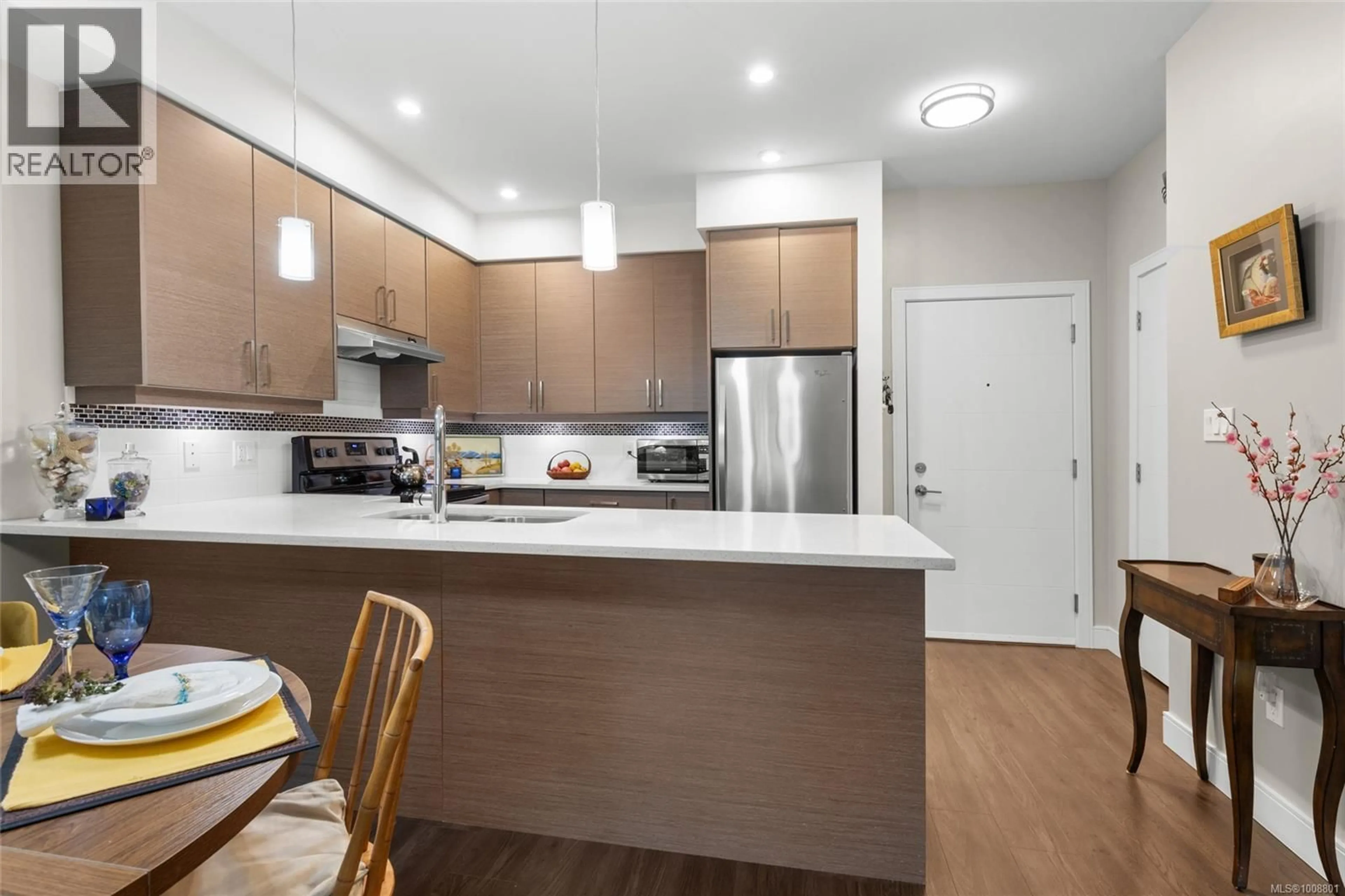 Open concept kitchen, wood/laminate floor for 203 - 7111 WEST SAANICH ROAD, Central Saanich British Columbia V8M1P7