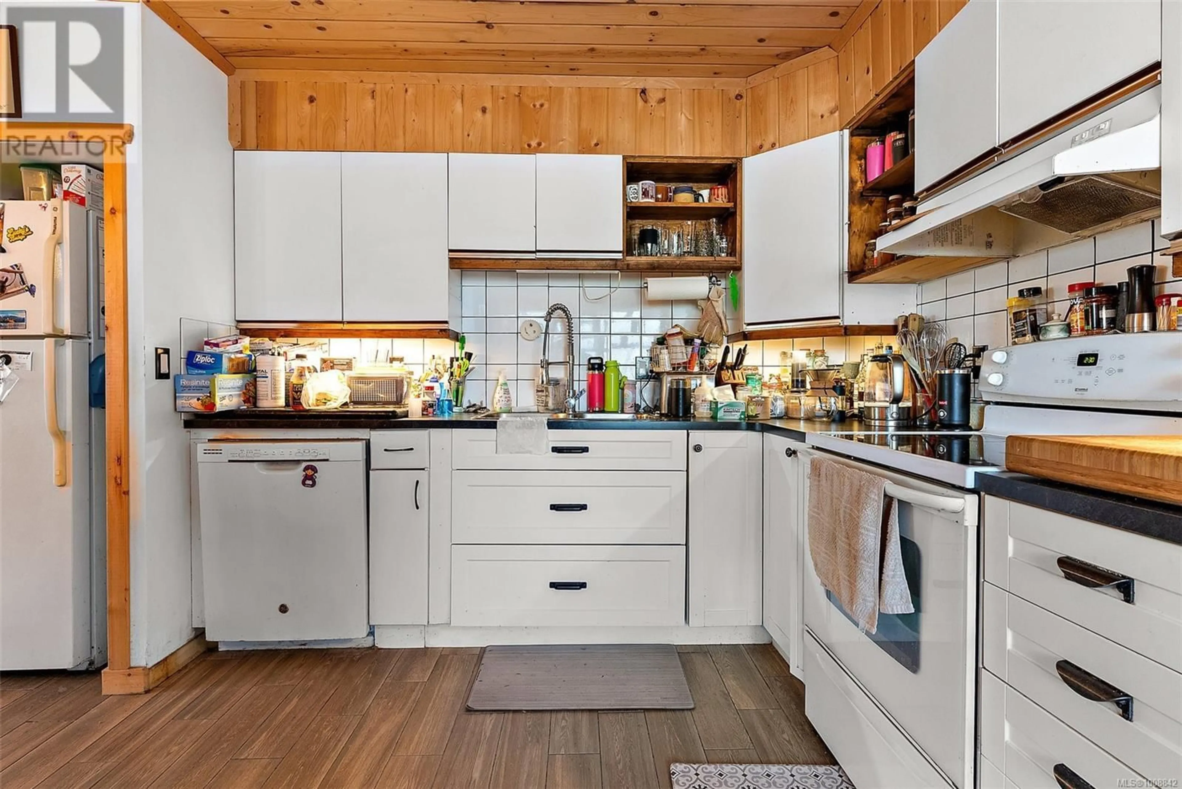 Open concept kitchen, wood/laminate floor for 3176 BALFOUR AVENUE, Victoria British Columbia V9A1S1