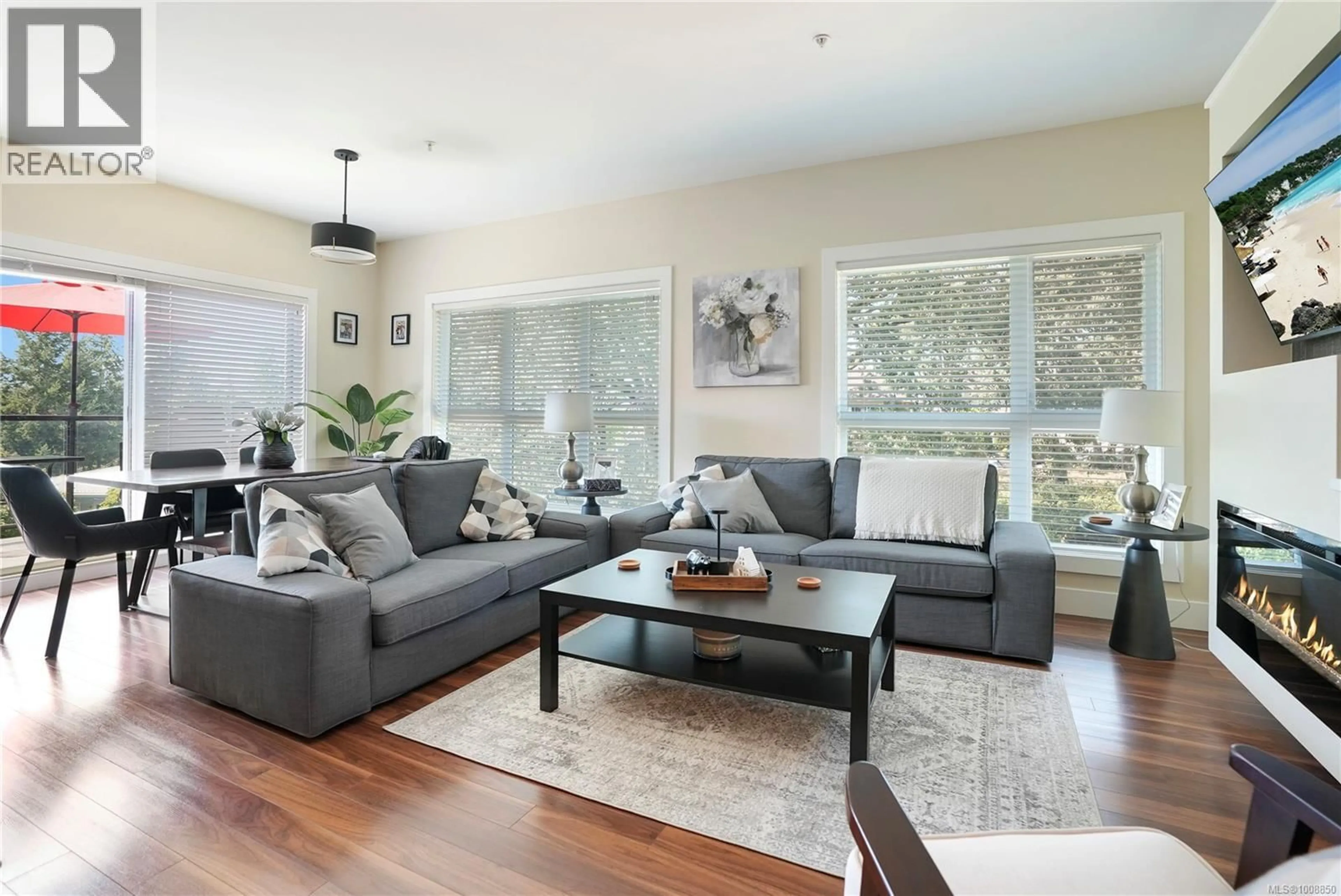 Living room with furniture, wood/laminate floor for 304 - 740 TRAVINO LANE, Saanich British Columbia V8Z0E2
