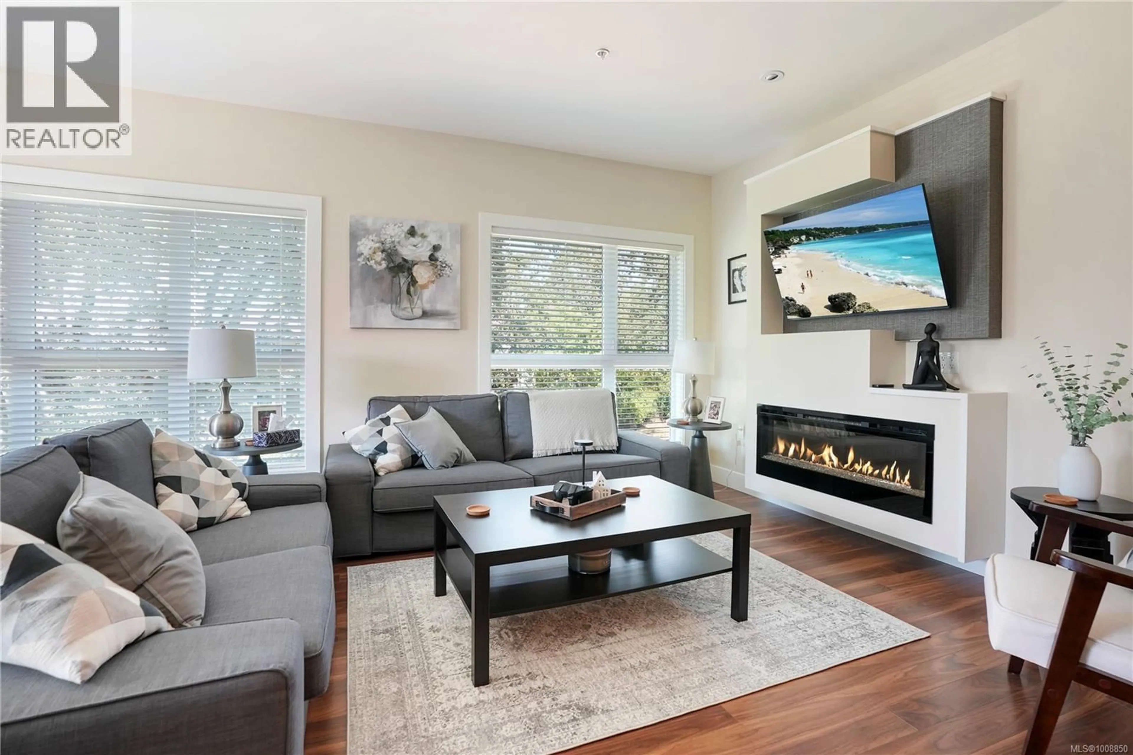 Living room with furniture, wood/laminate floor for 304 - 740 TRAVINO LANE, Saanich British Columbia V8Z0E2