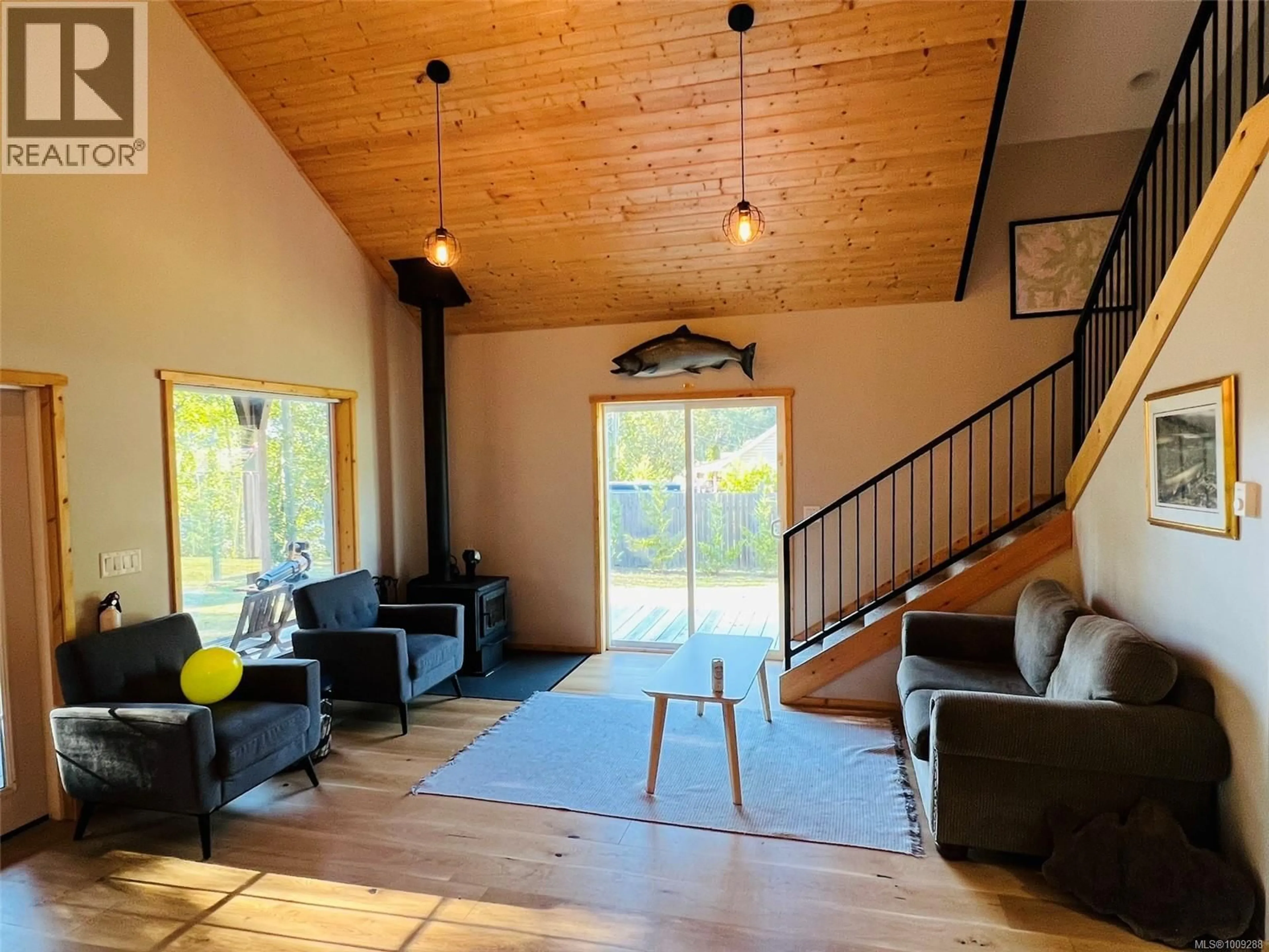 Living room with furniture, wood/laminate floor for 28 HOOMAK AVENUE, Woss British Columbia V0N3P0