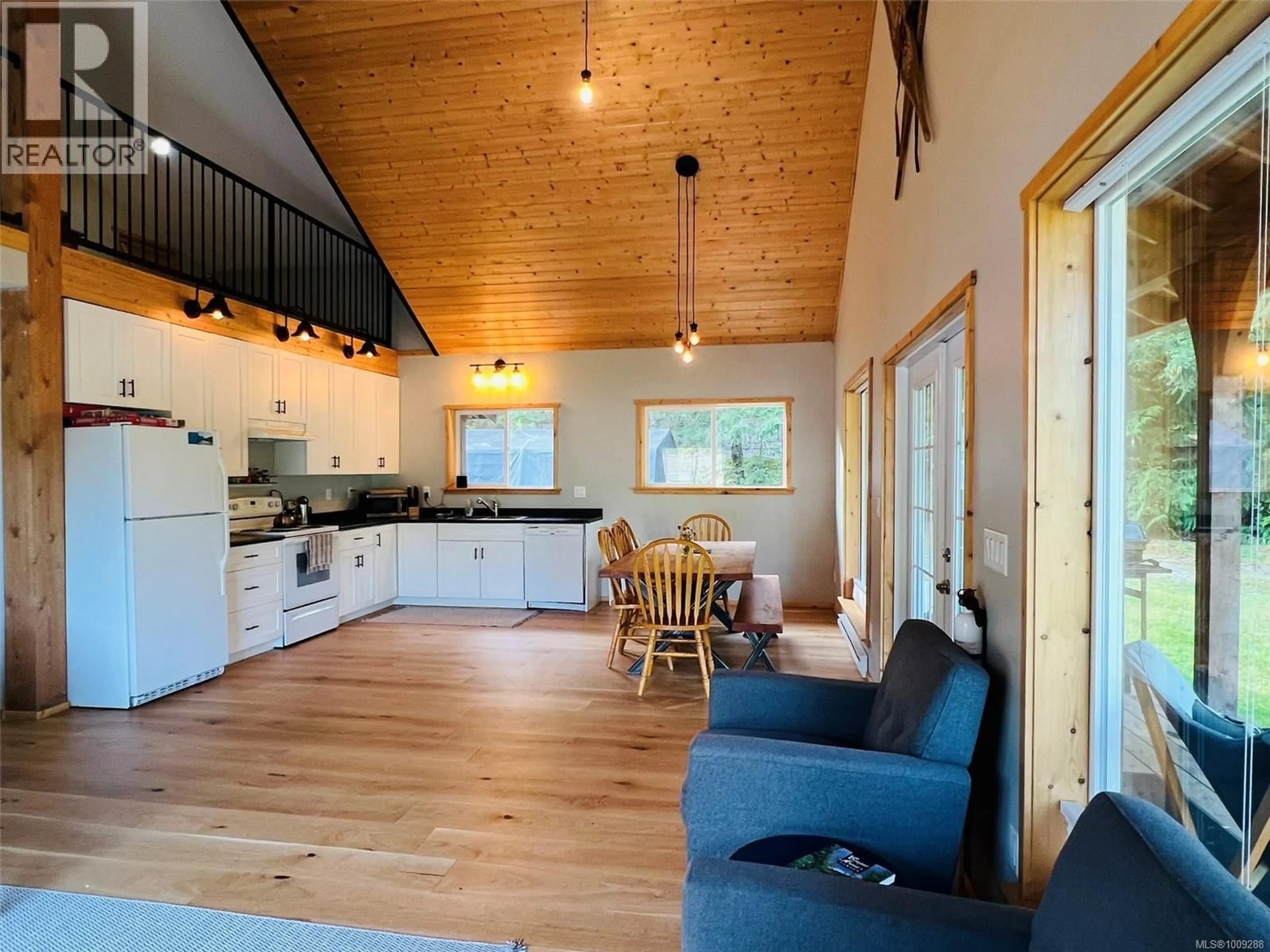 Open concept kitchen, wood/laminate floor for 28 HOOMAK AVENUE, Woss British Columbia V0N3P0