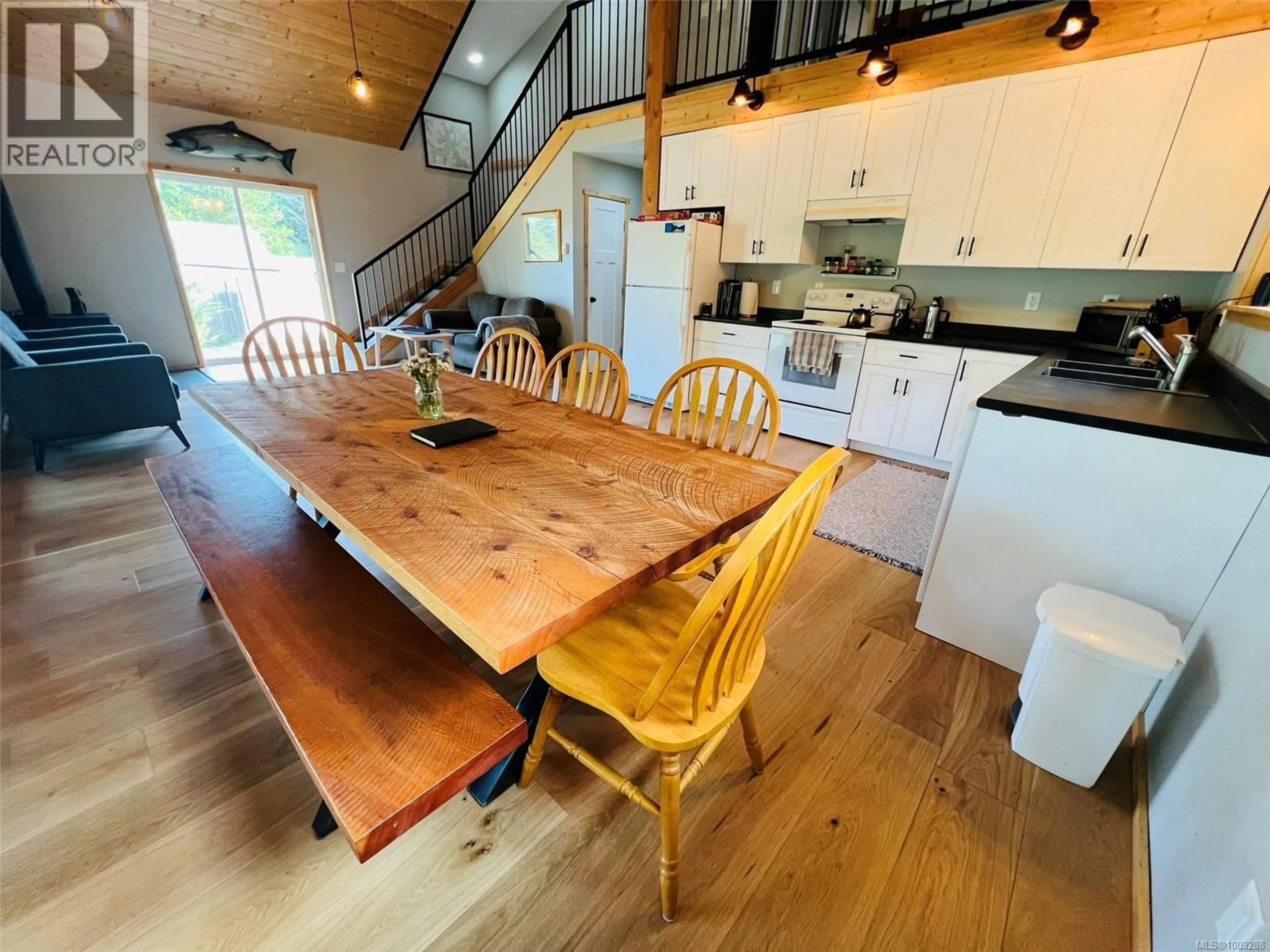 Open concept kitchen, wood/laminate floor for 28 HOOMAK AVENUE, Woss British Columbia V0N3P0
