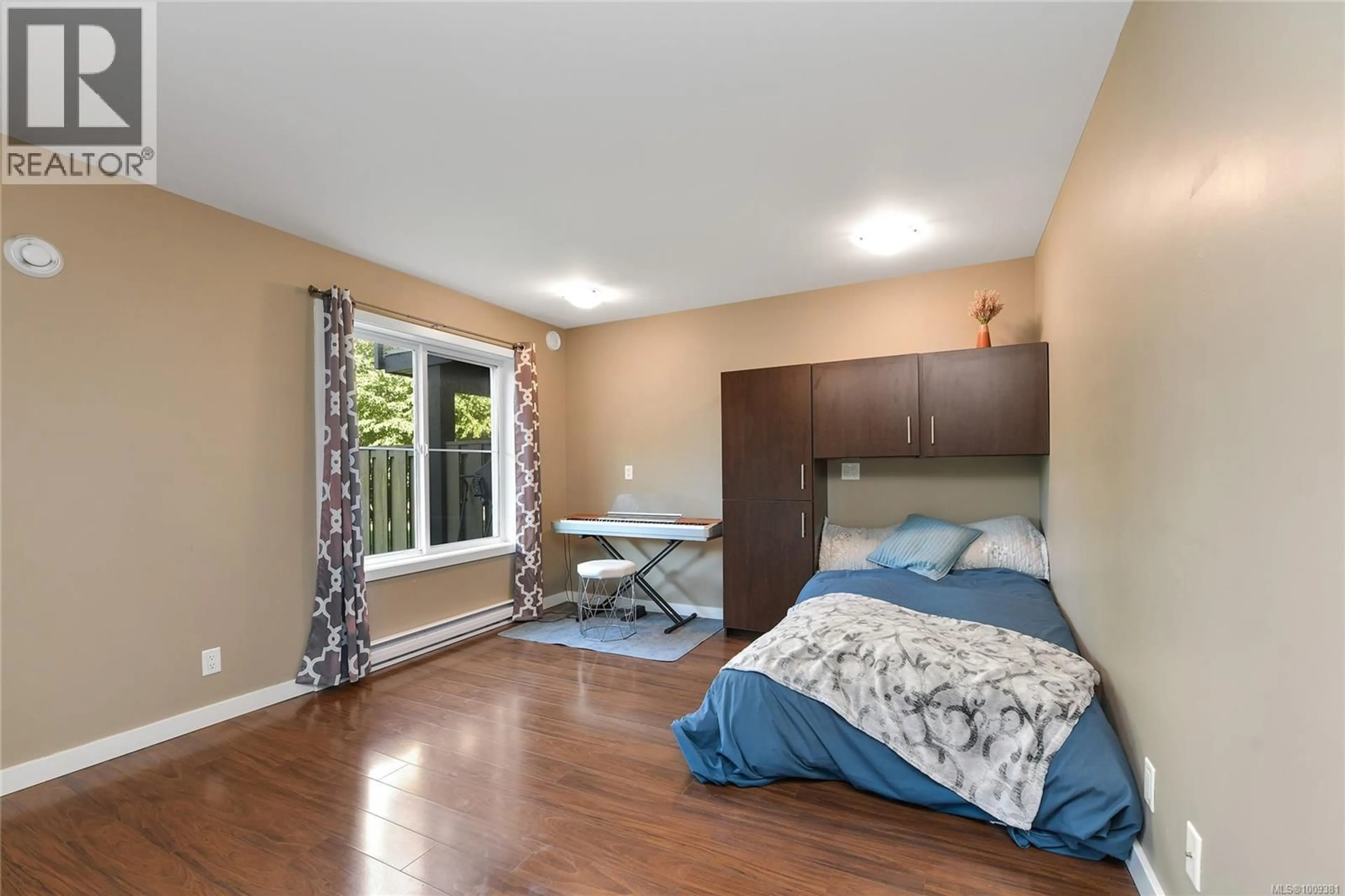 Bedroom with bed, wood/laminate floor for 984 FIREHALL CREEK ROAD, Langford British Columbia V9C0A2