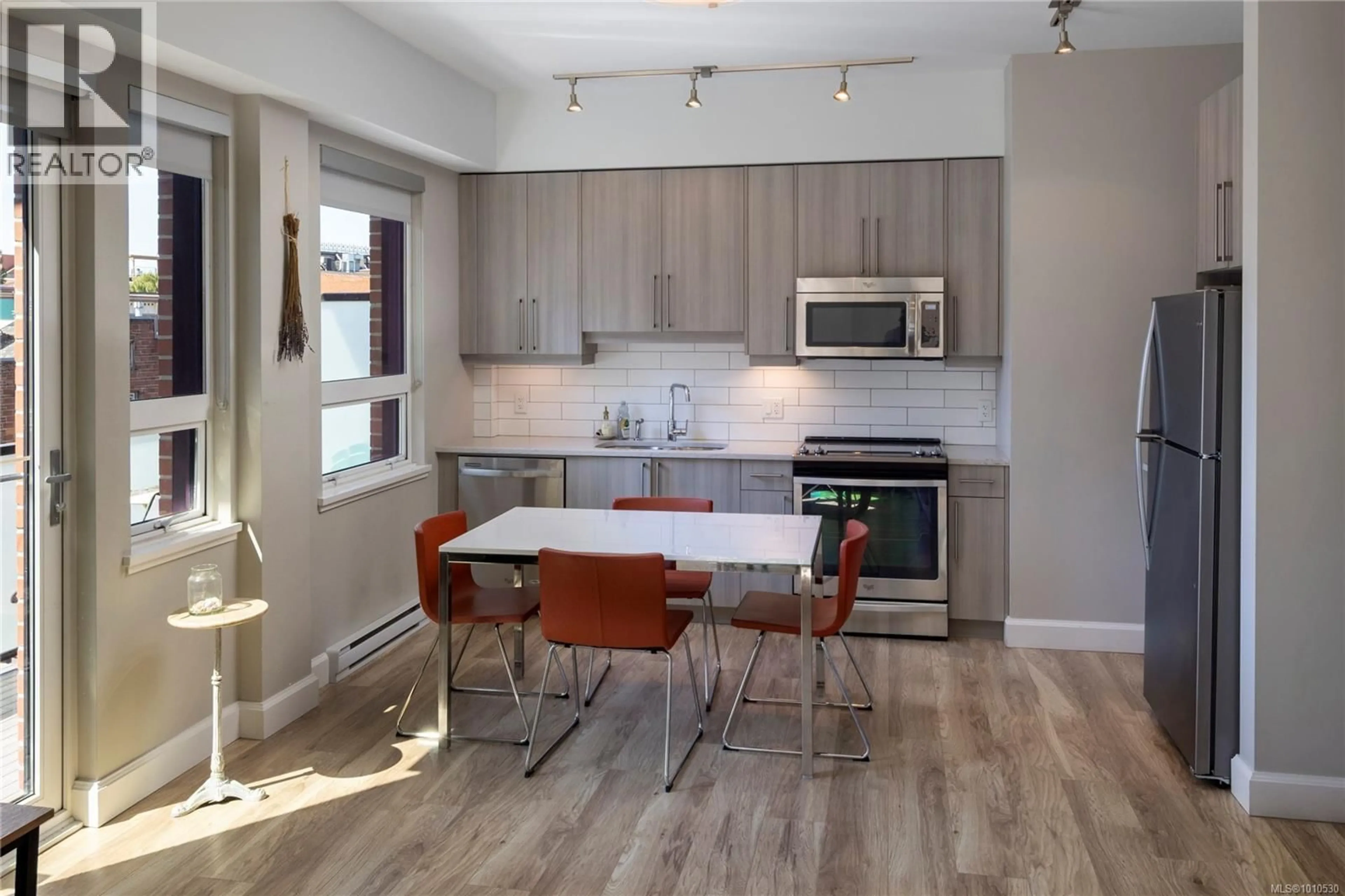 Open concept kitchen, wood/laminate floor for 307 - 595 PANDORA AVENUE, Victoria British Columbia V8W1N5
