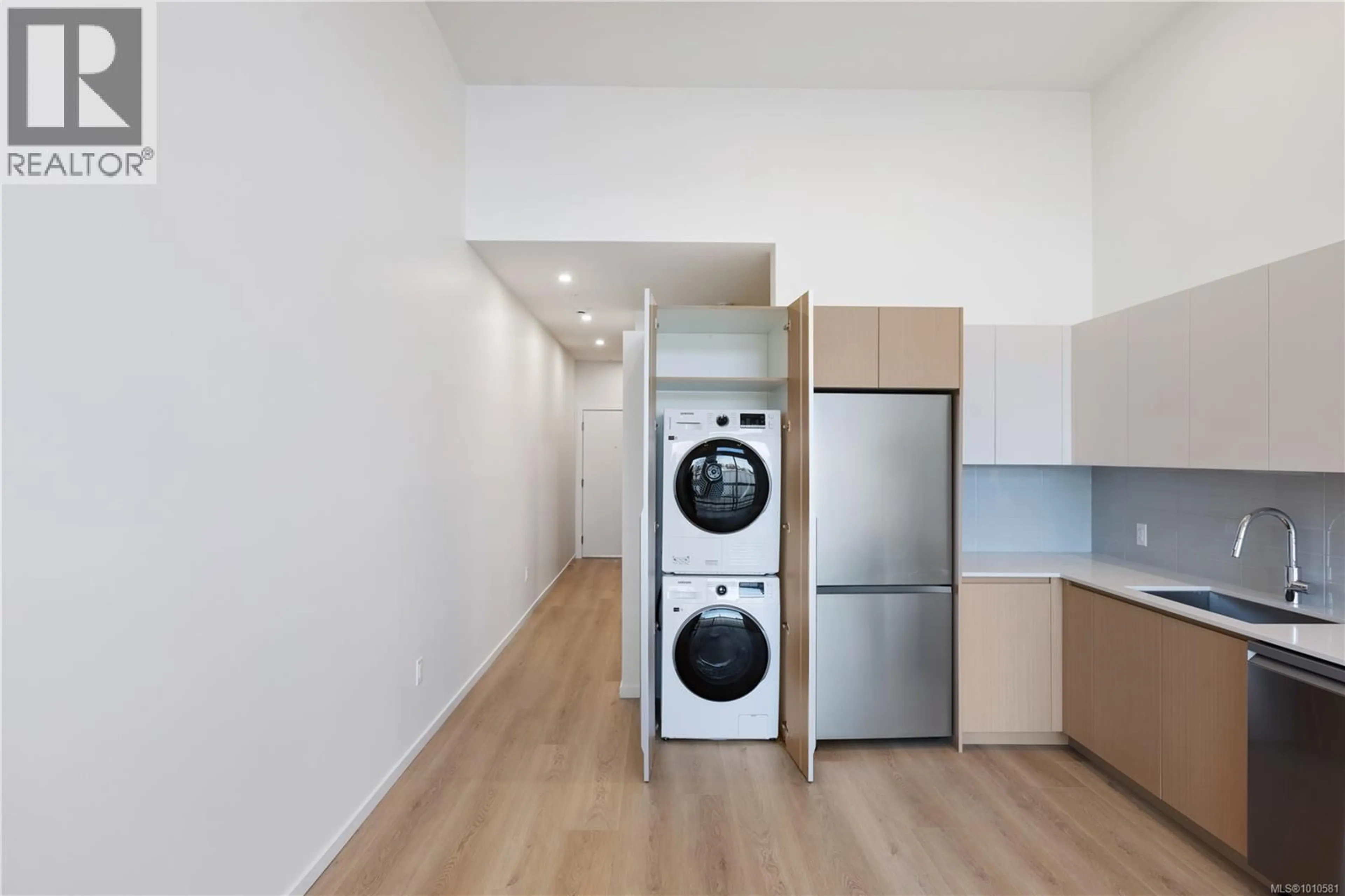 Kitchen with laundary machines, wood/laminate floor for 203 - 2374 OAKVILLE AVENUE, Sidney British Columbia V8L1V5