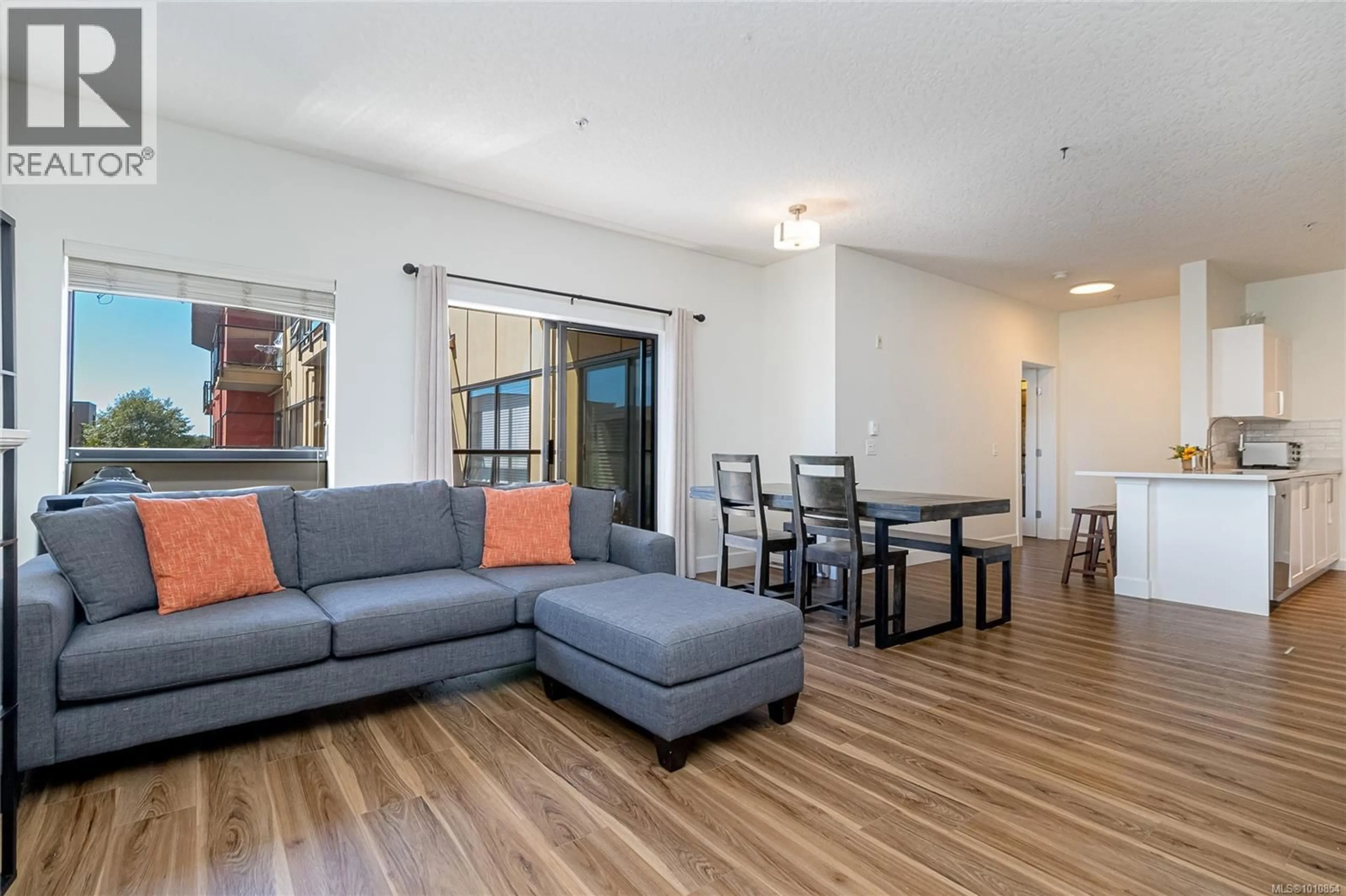 Living room with furniture, wood/laminate floor for 408 - 870 SHORT STREET, Saanich British Columbia V8X2V5