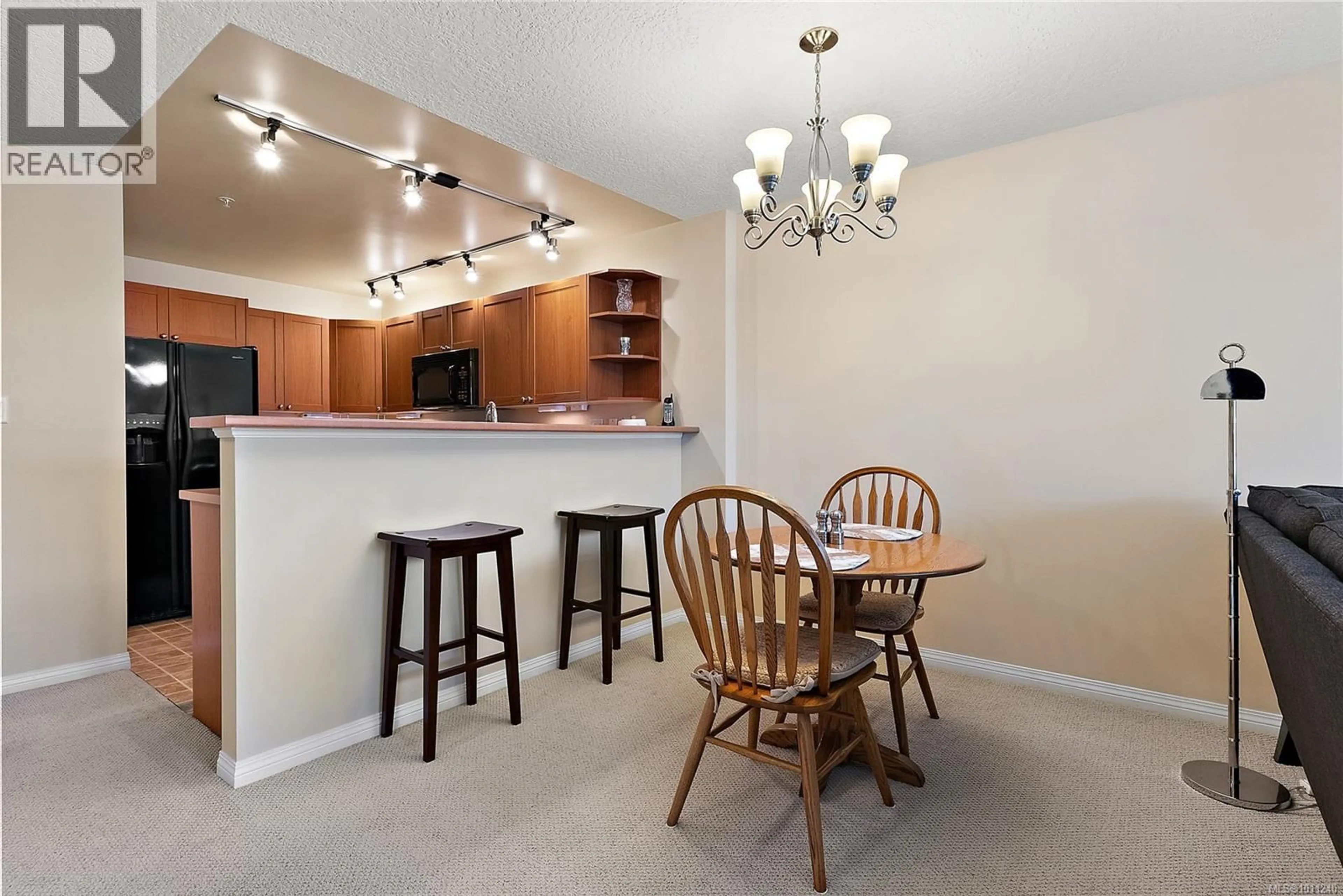 Open concept kitchen, wood/laminate floor for 302 - 9840 FIFTH STREET, Sidney British Columbia V9L2X3