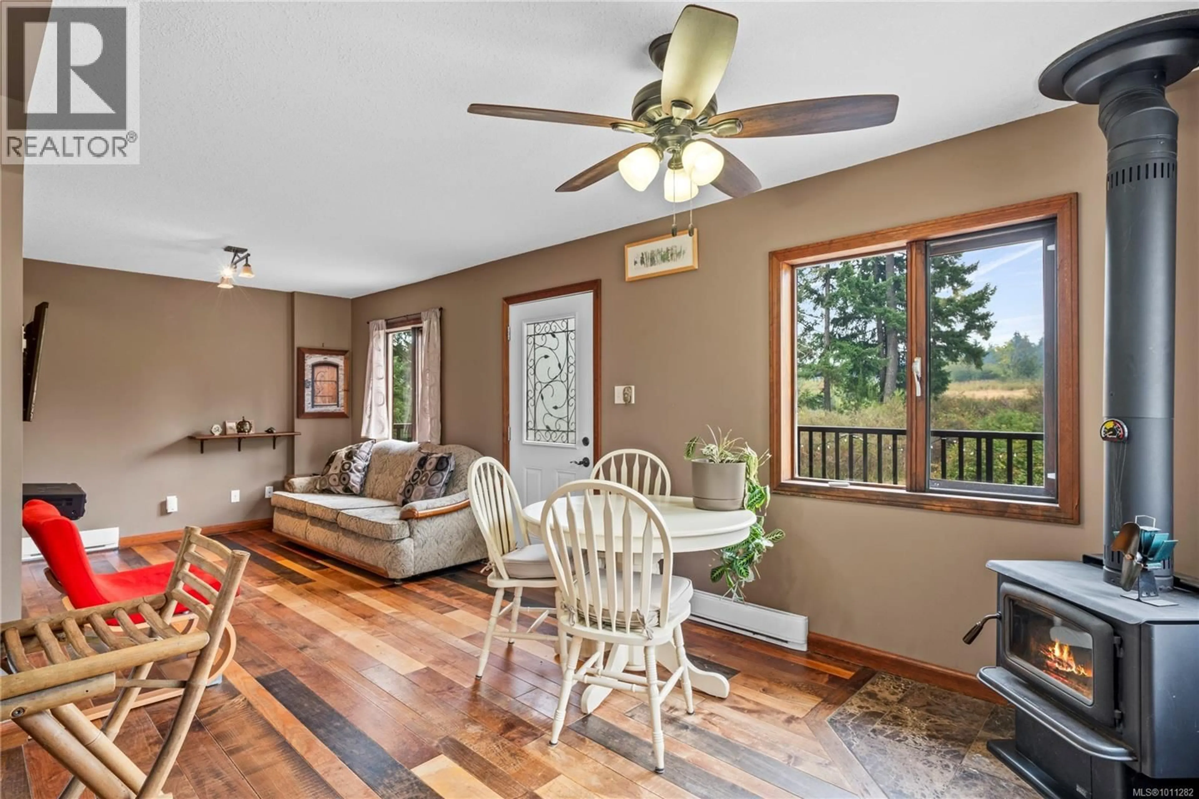 Living room with furniture, wood/laminate floor for 2975 THORPE ROAD, Qualicum Beach British Columbia V9K1Z7