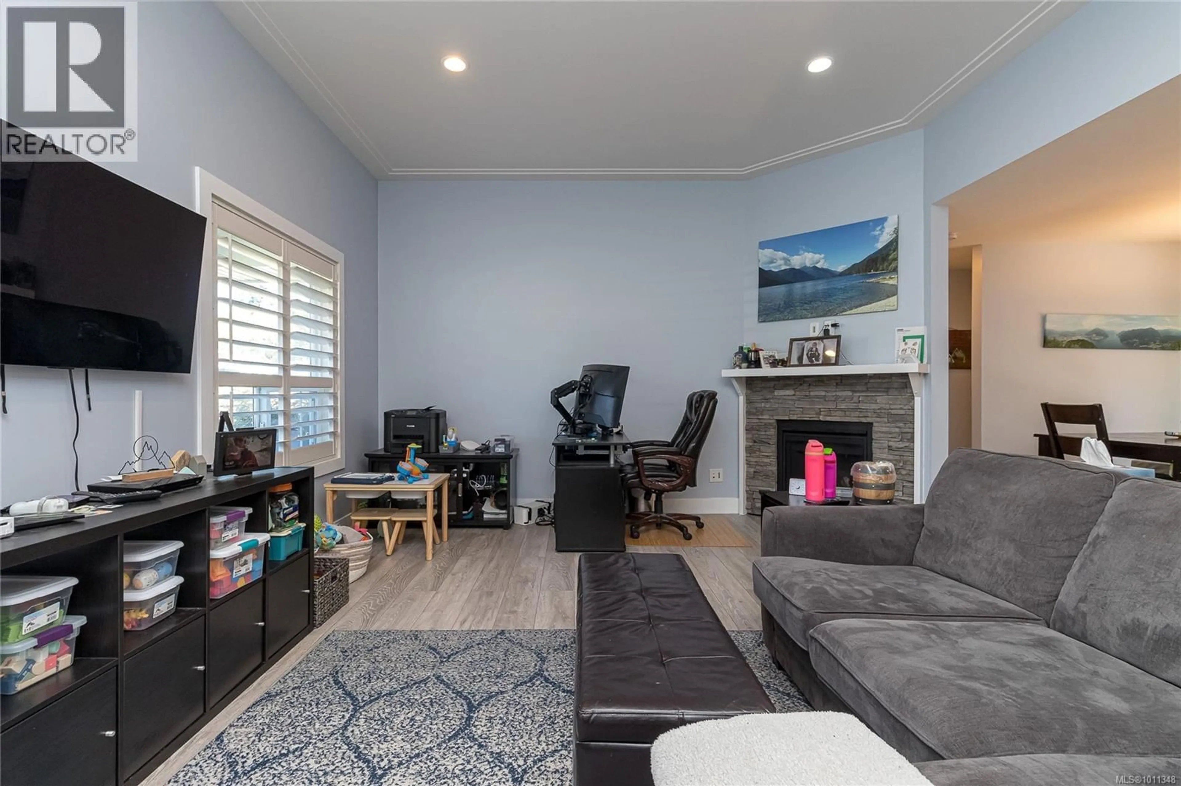 Living room with furniture, wood/laminate floor for 6885 LAURA'S LANE, Sooke British Columbia V9Z0P8