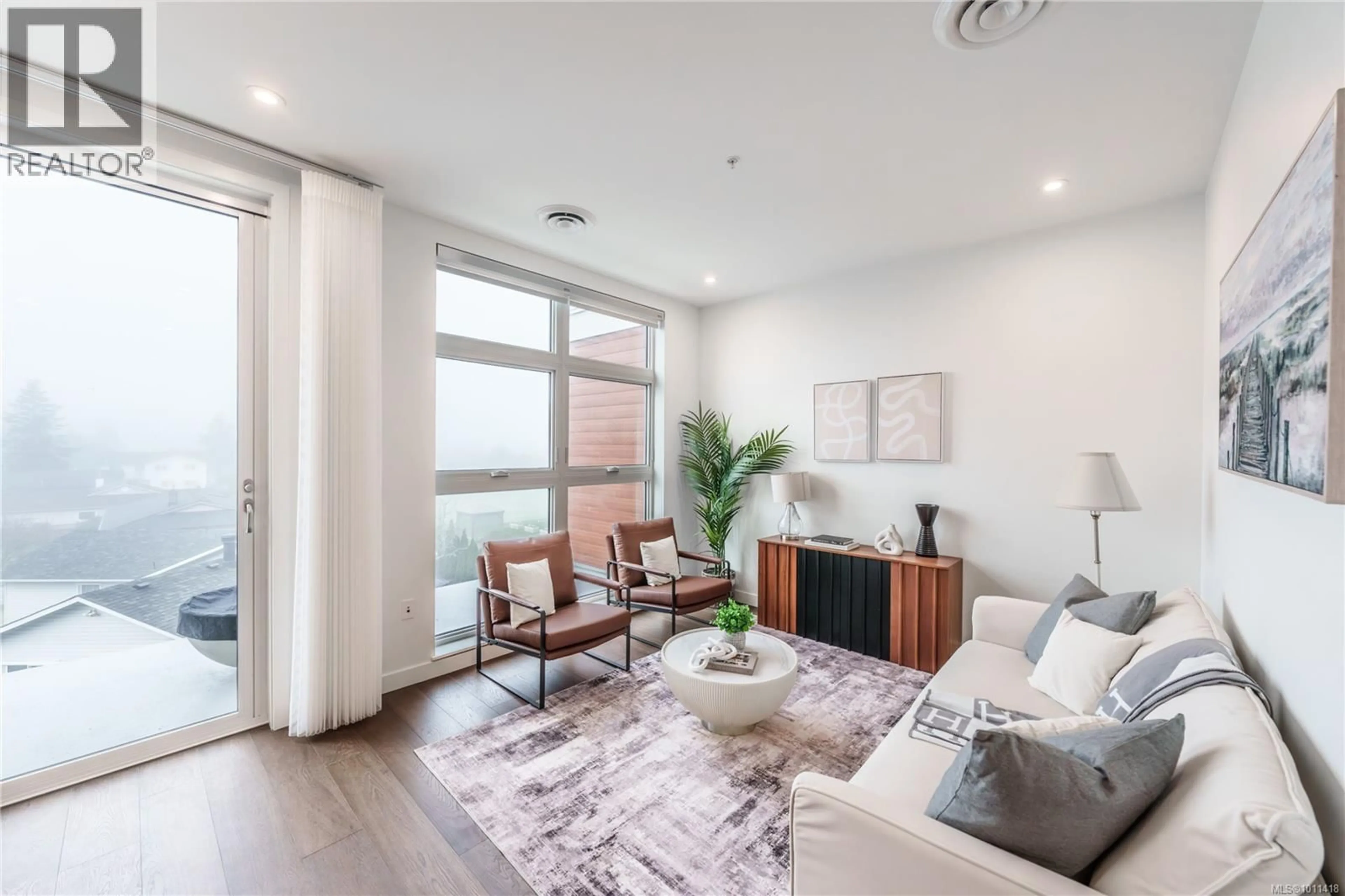 Living room with furniture, wood/laminate floor for 308 - 9570 FIFTH STREET, Sidney British Columbia V8L2W5