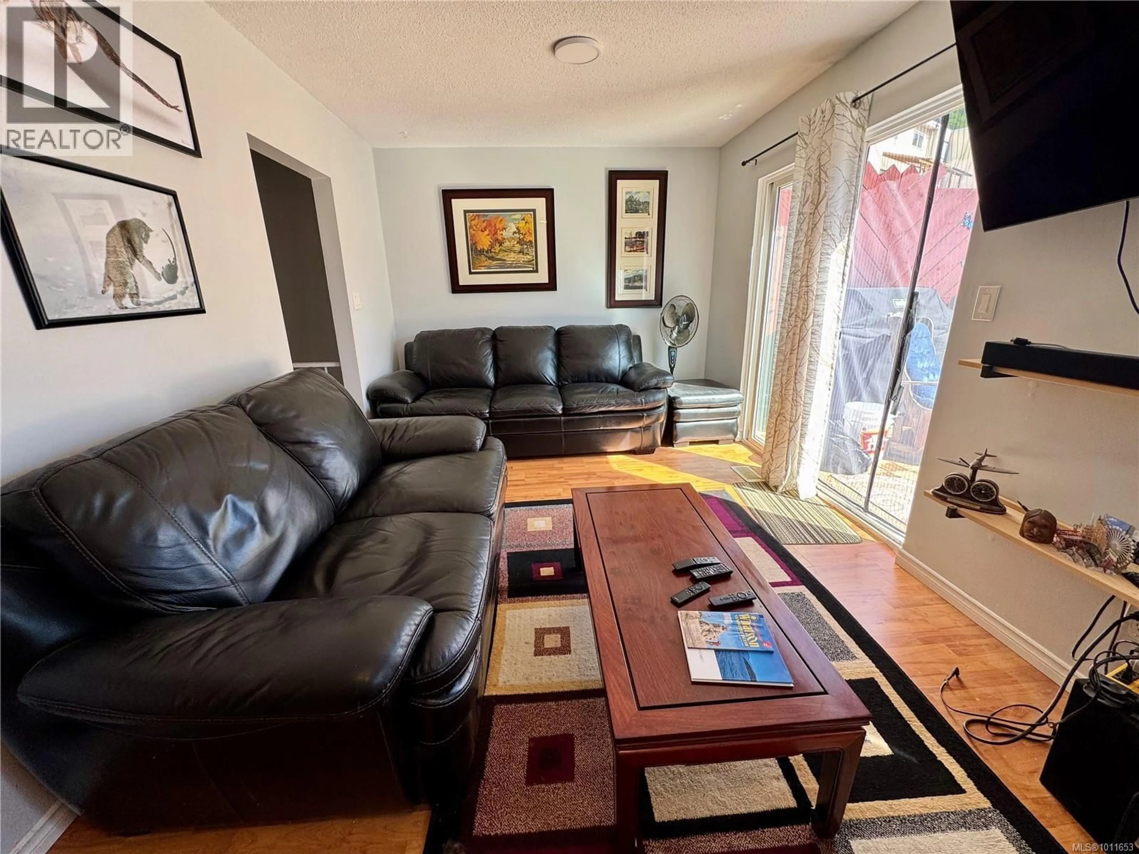 Living room with furniture, wood/laminate floor for 92 MCKAY CRESCENT, Port Alice British Columbia V0N2N0