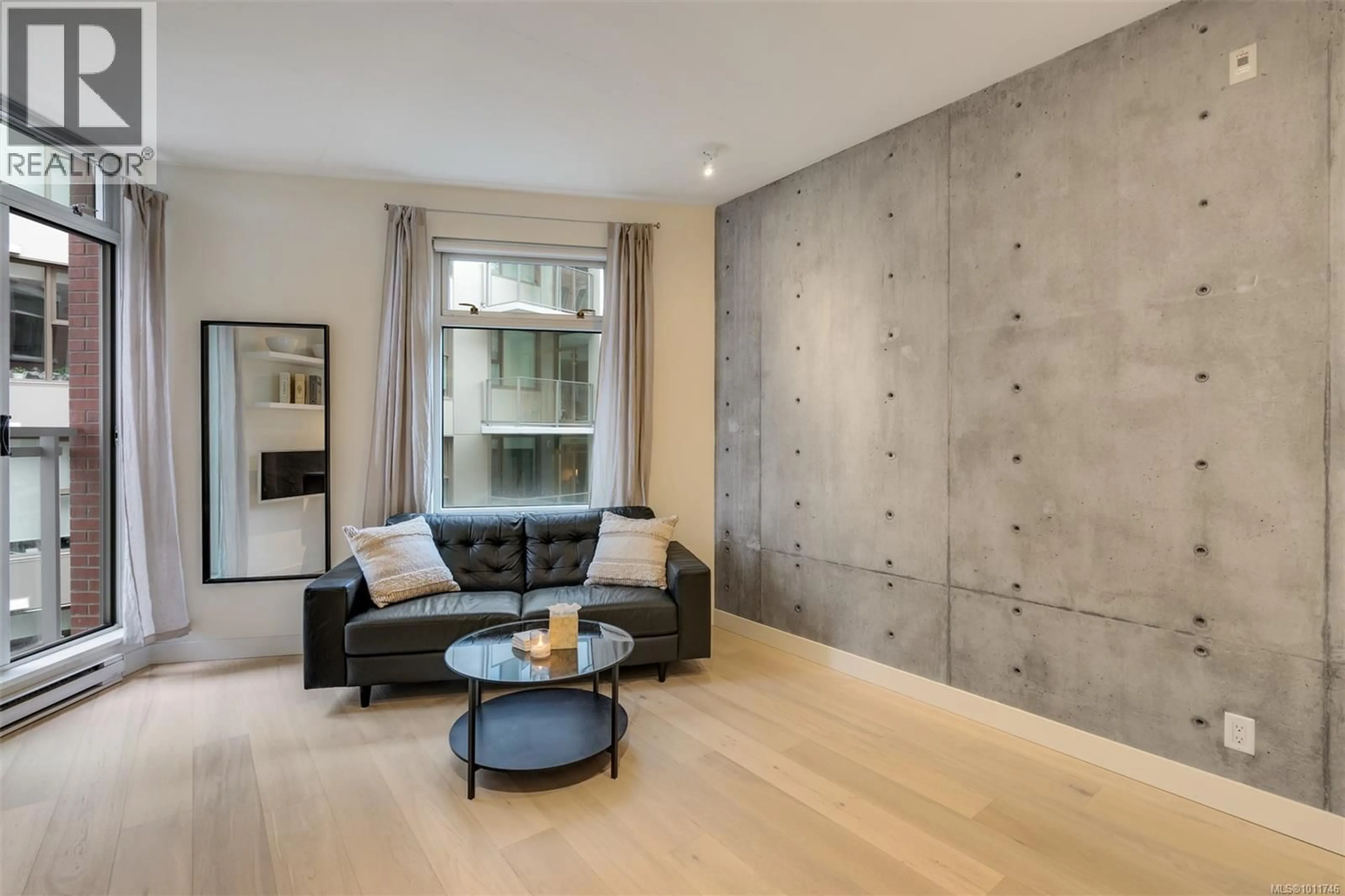 Living room with furniture, cement floor for 102 - 456 PANDORA AVENUE, Victoria British Columbia V8W0E3