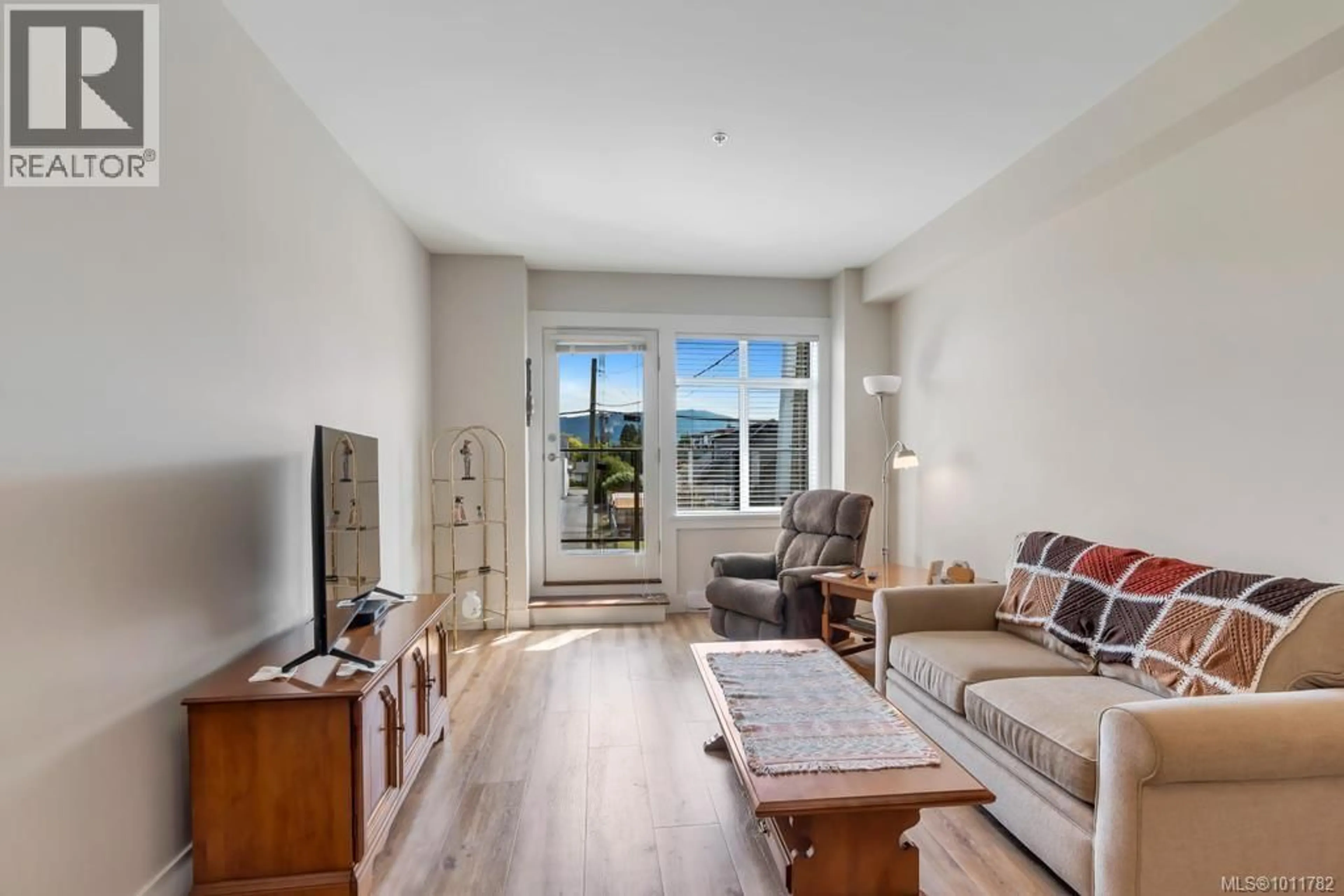 Living room with furniture, wood/laminate floor for 207 - 5822 GARDEN STREET, Duncan British Columbia V9L3V3