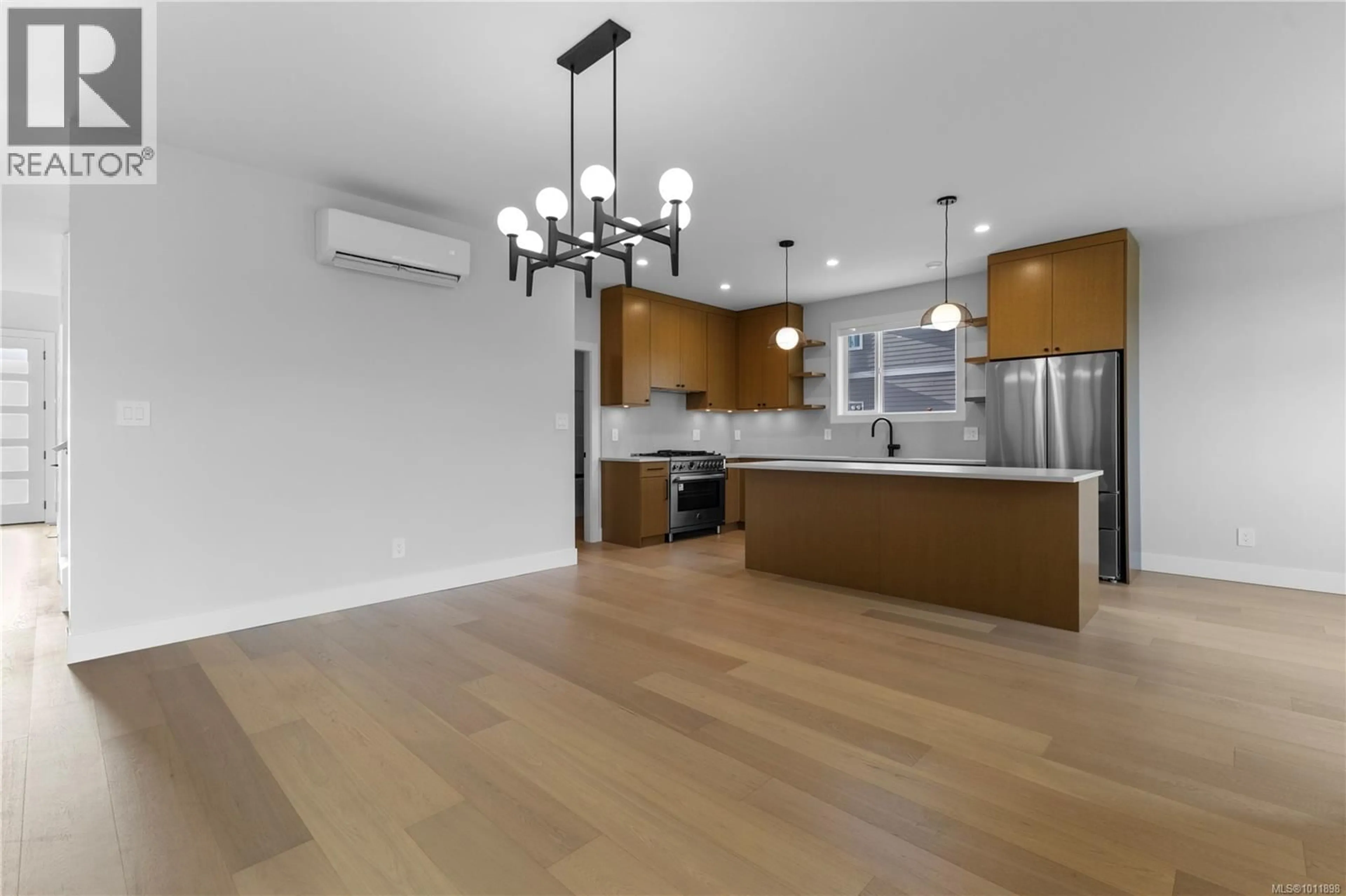 Open concept kitchen, wood/laminate floor for 1406 SANDSTONE LANE, Langford British Columbia V9B7A2