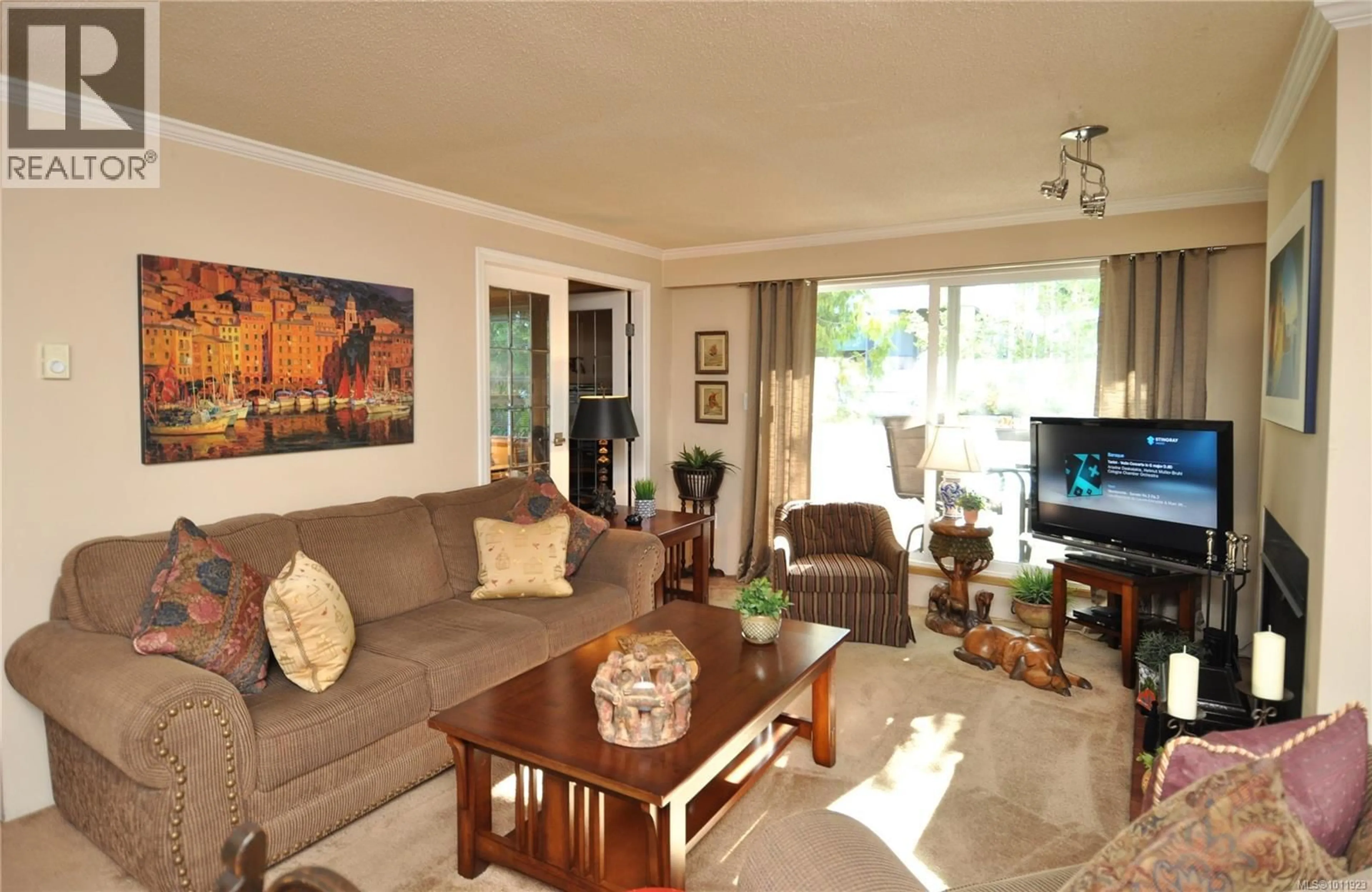 Living room with furniture, wood/laminate floor for 303 - 1068 TOLMIE AVENUE, Saanich British Columbia V8X4T4