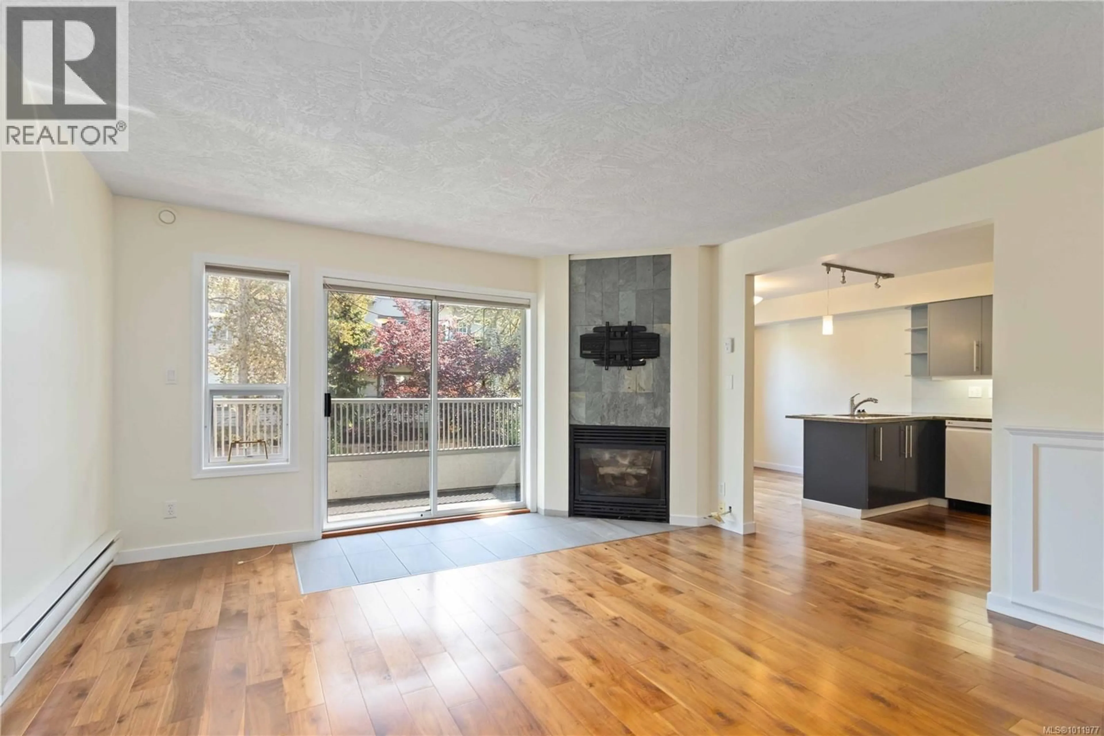 Living room with furniture, wood/laminate floor for 205 - 9945 FIFTH STREET, Sidney British Columbia V8L2X6