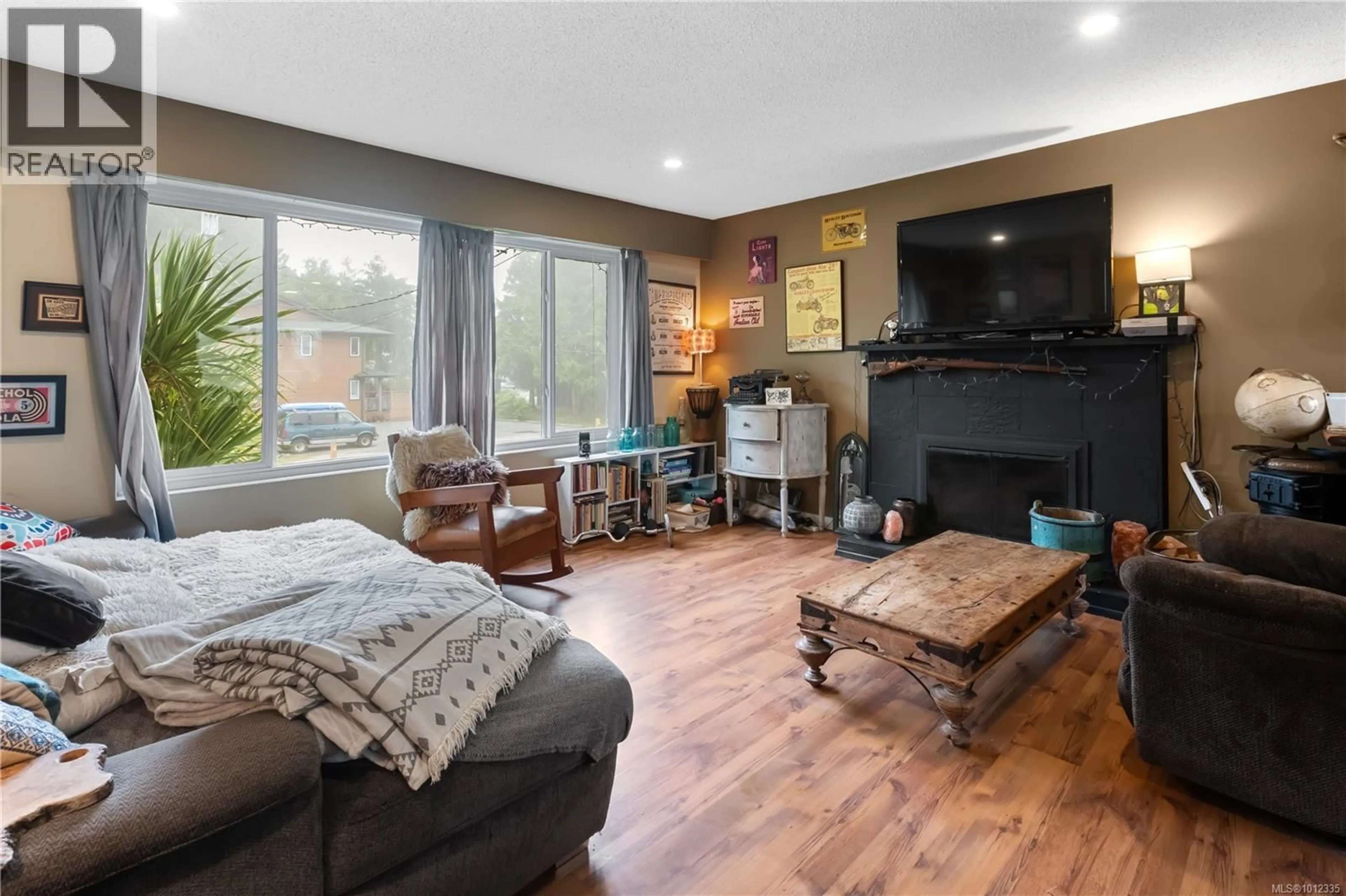 Living room with furniture, wood/laminate floor for 1550 LARCH ROAD, Ucluelet British Columbia V0R3A0
