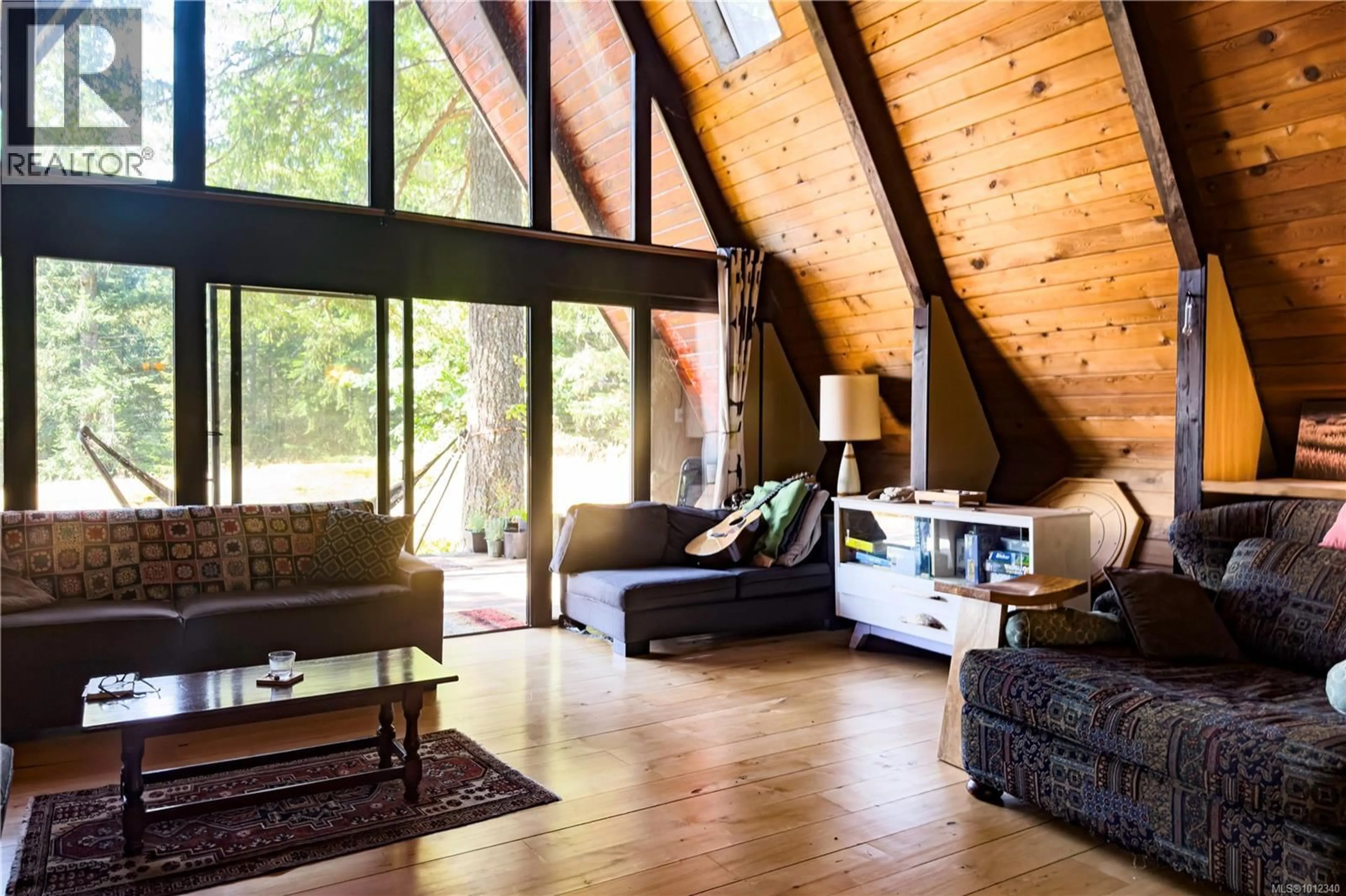 Living room with furniture, wood/laminate floor for 766 GOWLLAND HARBOUR ROAD, Quadra Island British Columbia V0P1N0