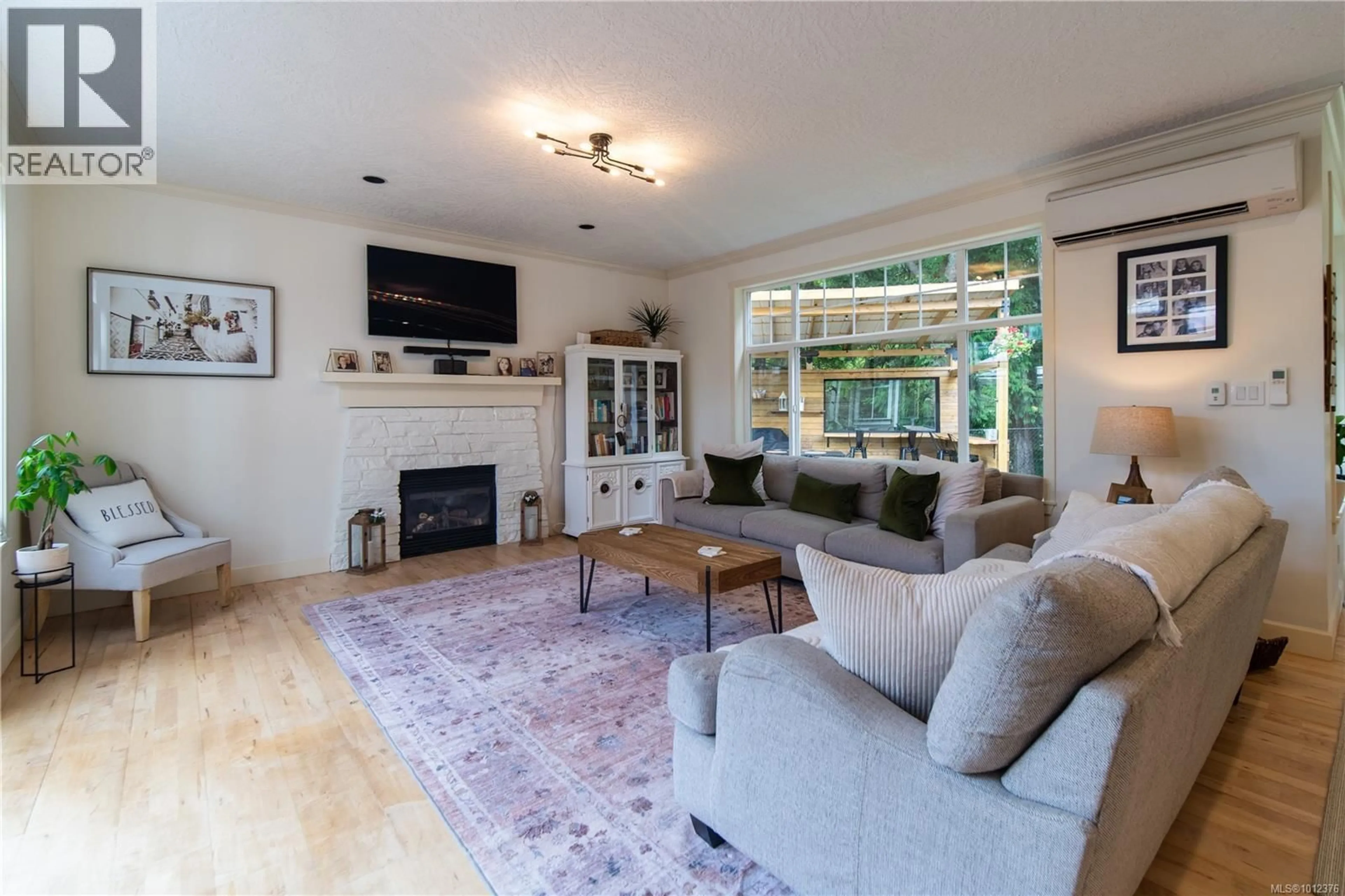 Living room with furniture, wood/laminate floor for 2372 DEMAMIEL DRIVE, Sooke British Columbia V9Z0Y4