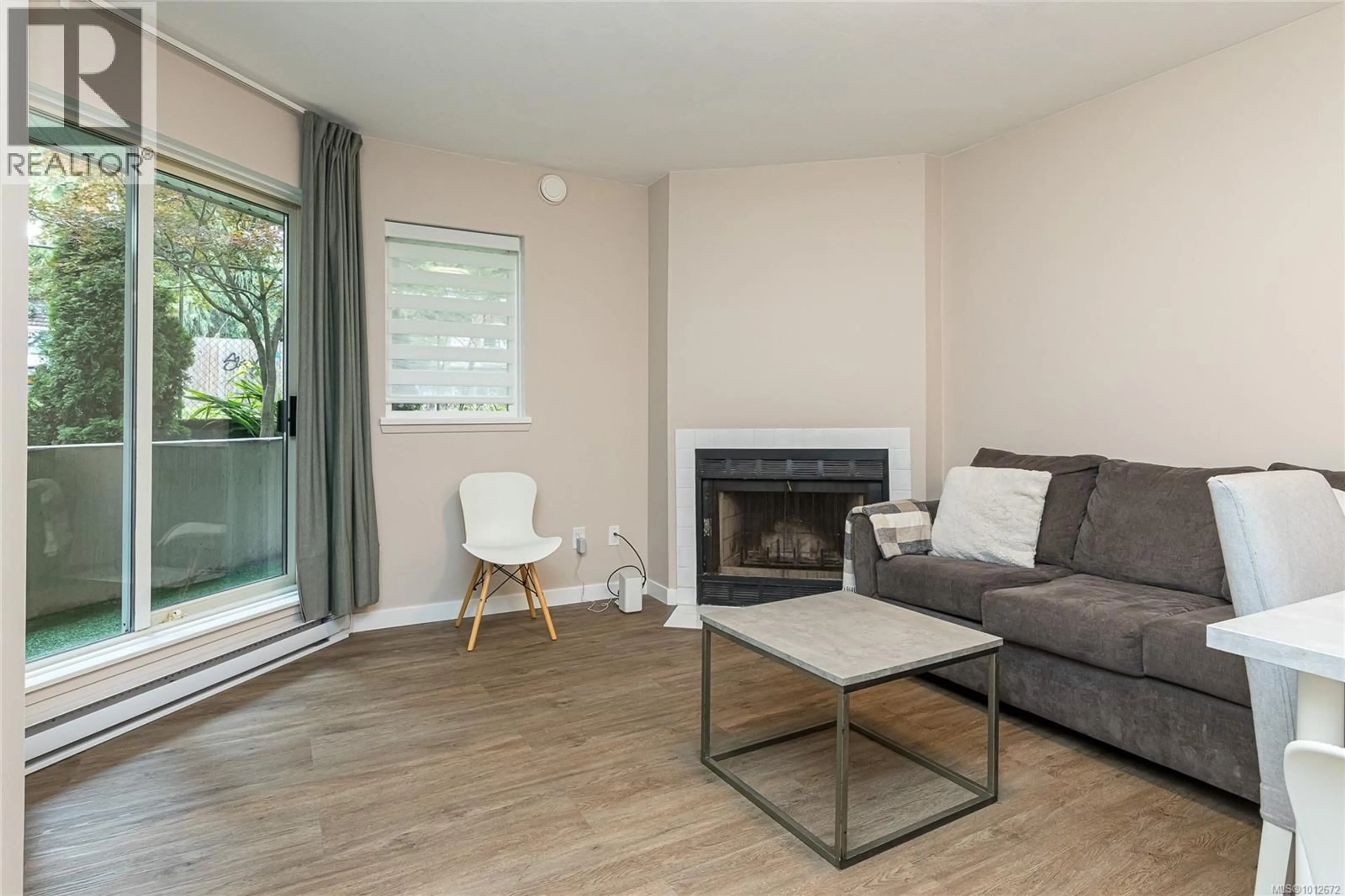 Living room with furniture, wood/laminate floor for 106 - 2520 WARK STREET, Victoria British Columbia V8T5G6