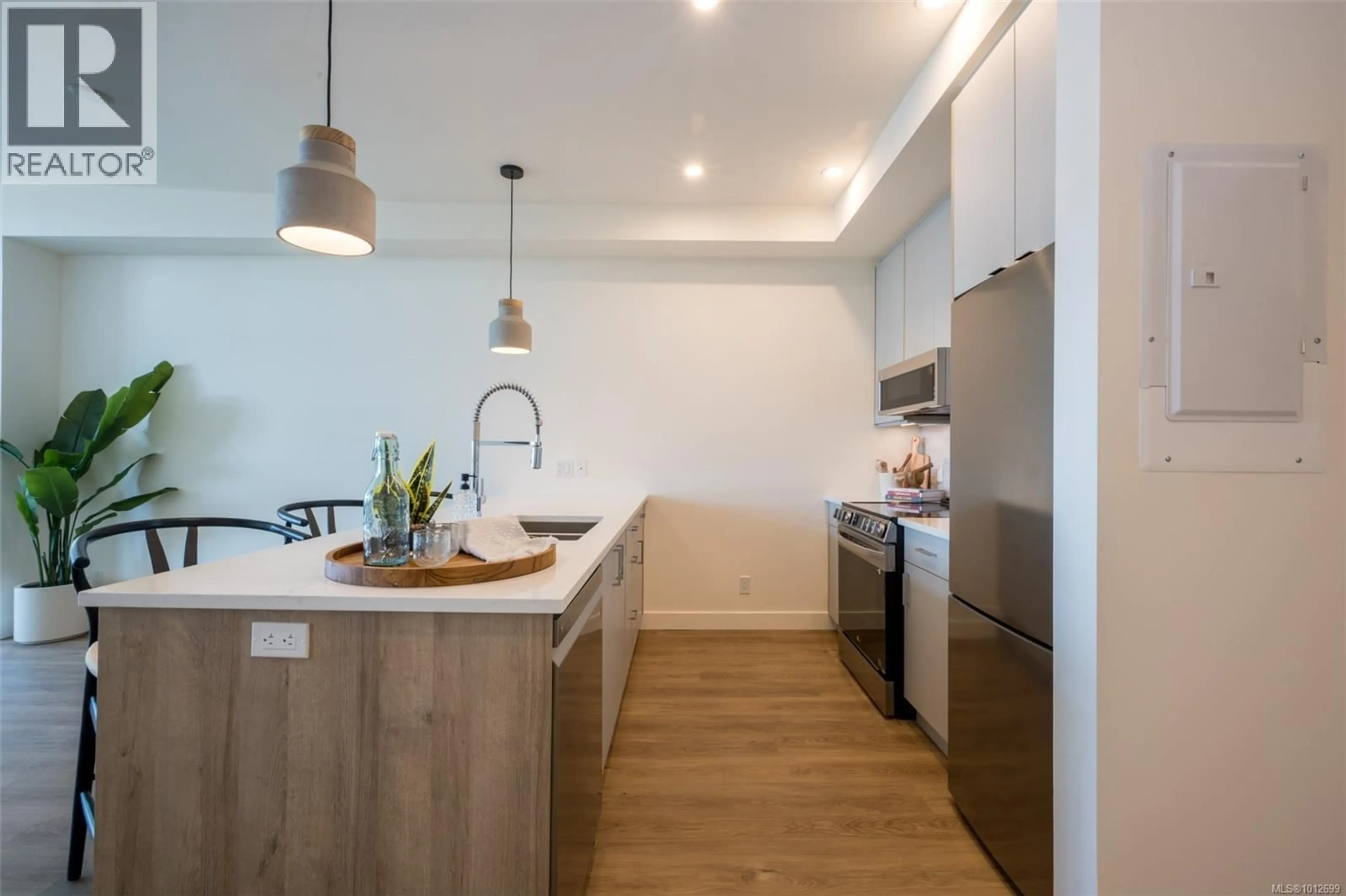 Open concept kitchen, wood/laminate floor for 402 - 757 TYEE ROAD, Victoria British Columbia V9A7P7